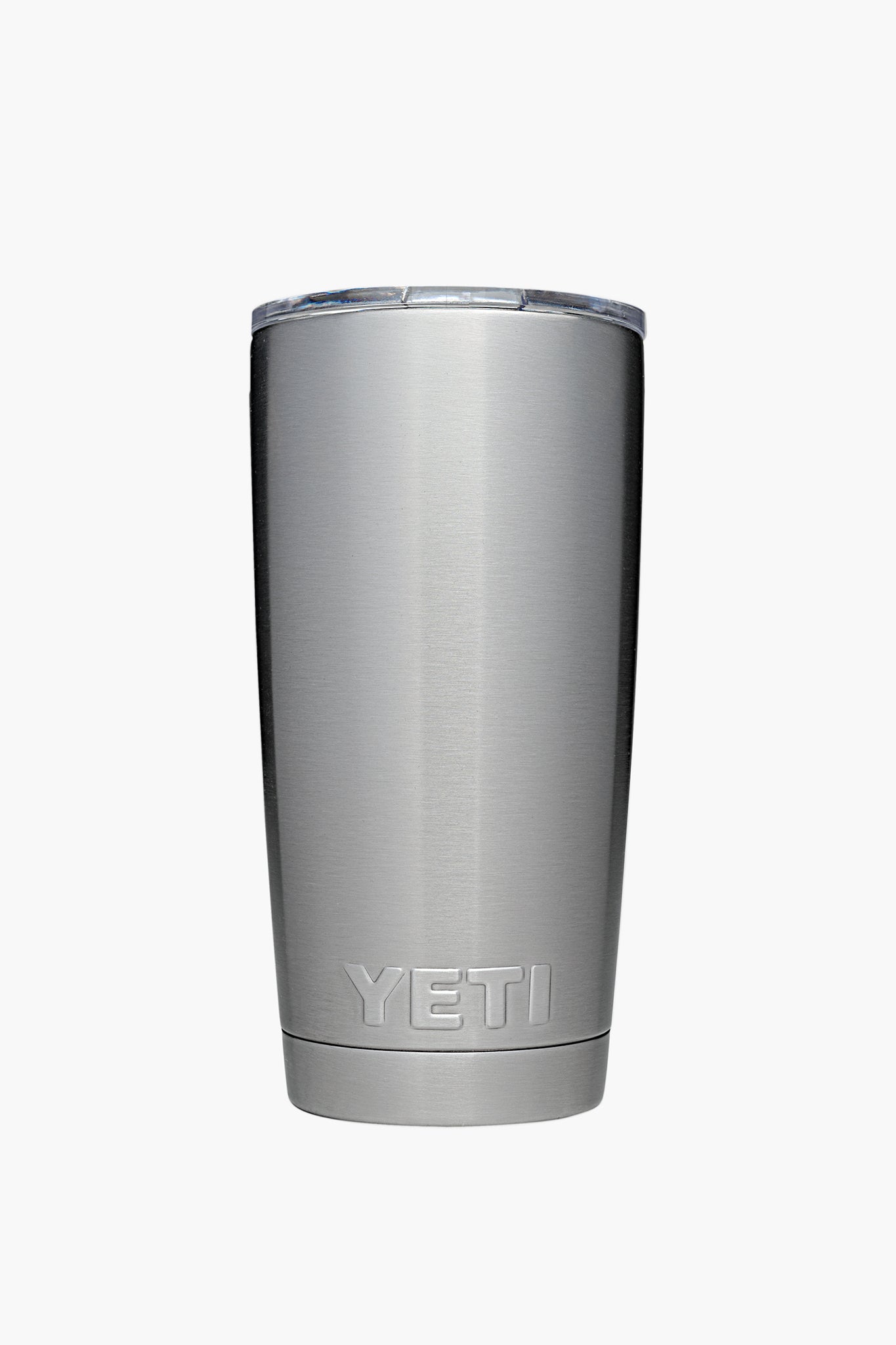 A YETI stainless steel tumbler with double-wall vacuum insulation and a transparent lid, shown standing upright.
