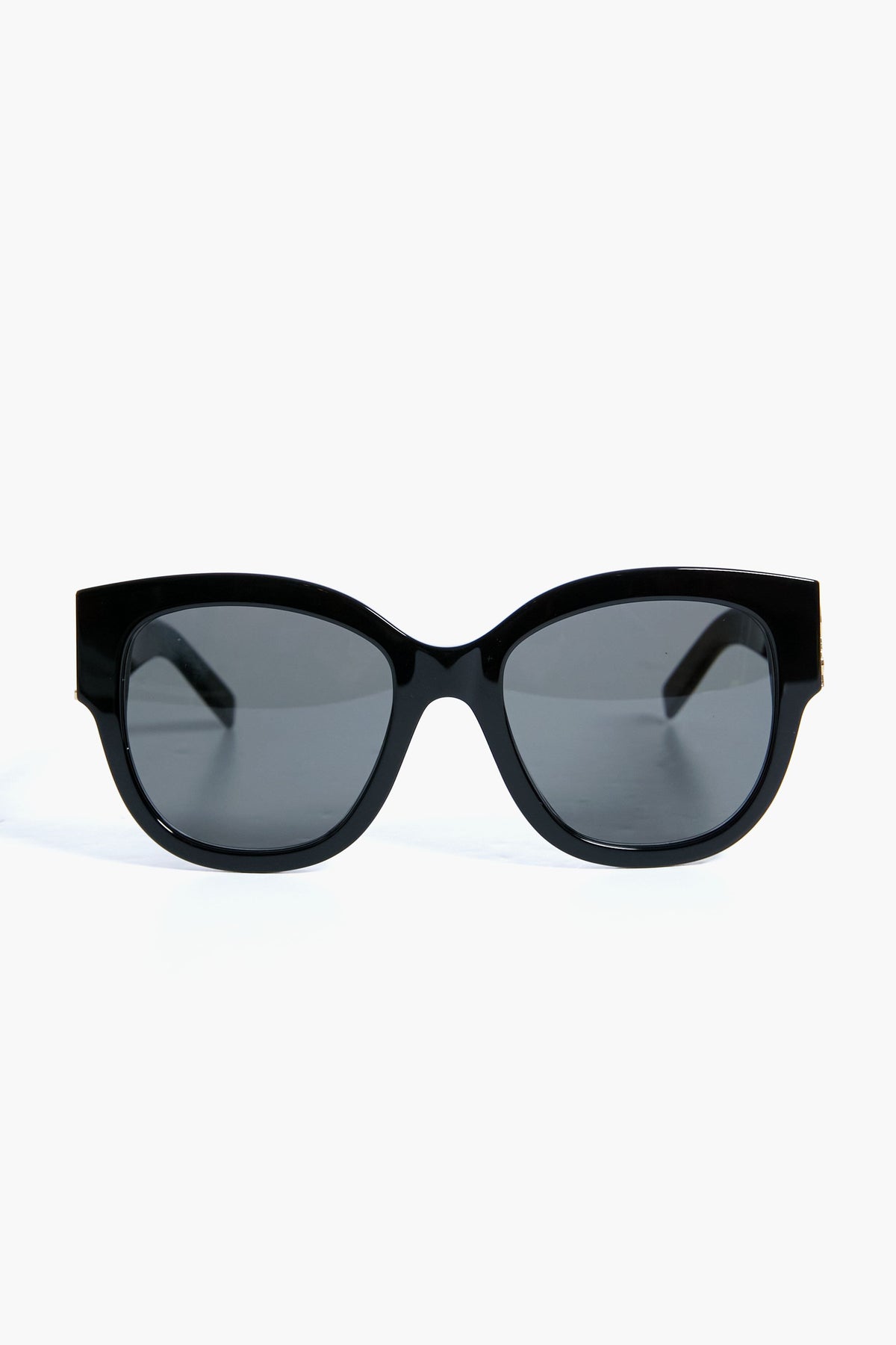 Saint Laurent black oval sunglasses with dark lenses, shown from the front. These sunglasses feature a sleek design inspired by the YSL logo.