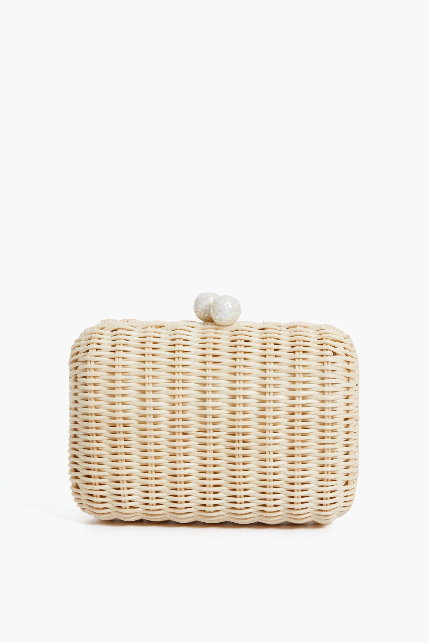 Kayu rectangular woven rattan clutch features a rounded shape and natural shell clasp, inspired by Filipino basketweaving.