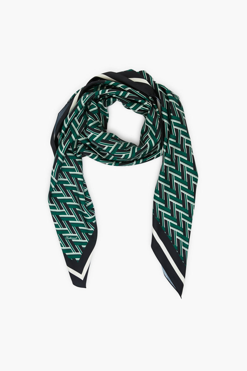 A green geometric print scarf by Tuckernuck Accessories, featuring a bold black and white zigzag pattern, angled ends, and a striking border—a standout style staple for any wardrobe.