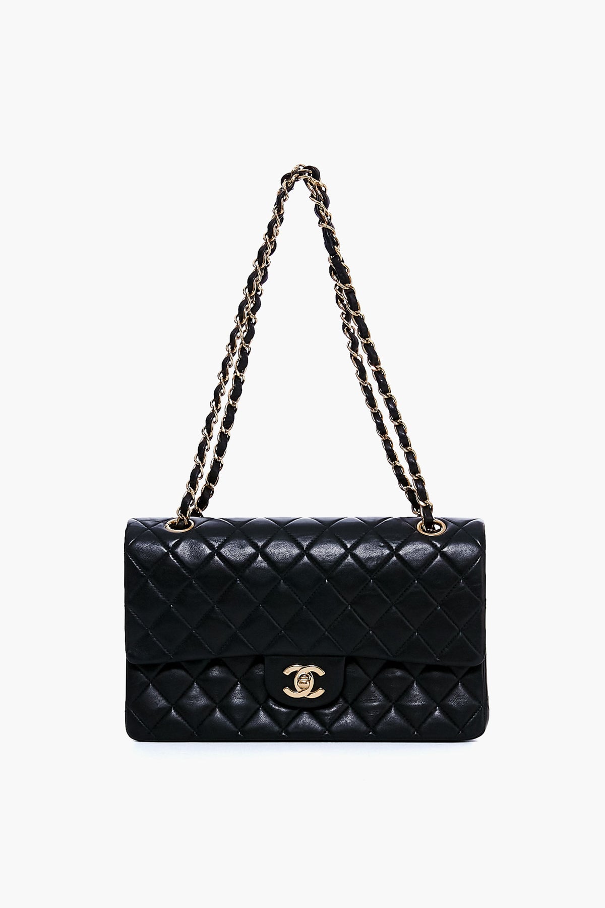 A black quilted leather Tuckernuck Archive Collection bag features a gold chain strap and a gold turn-lock clasp on the front flap.