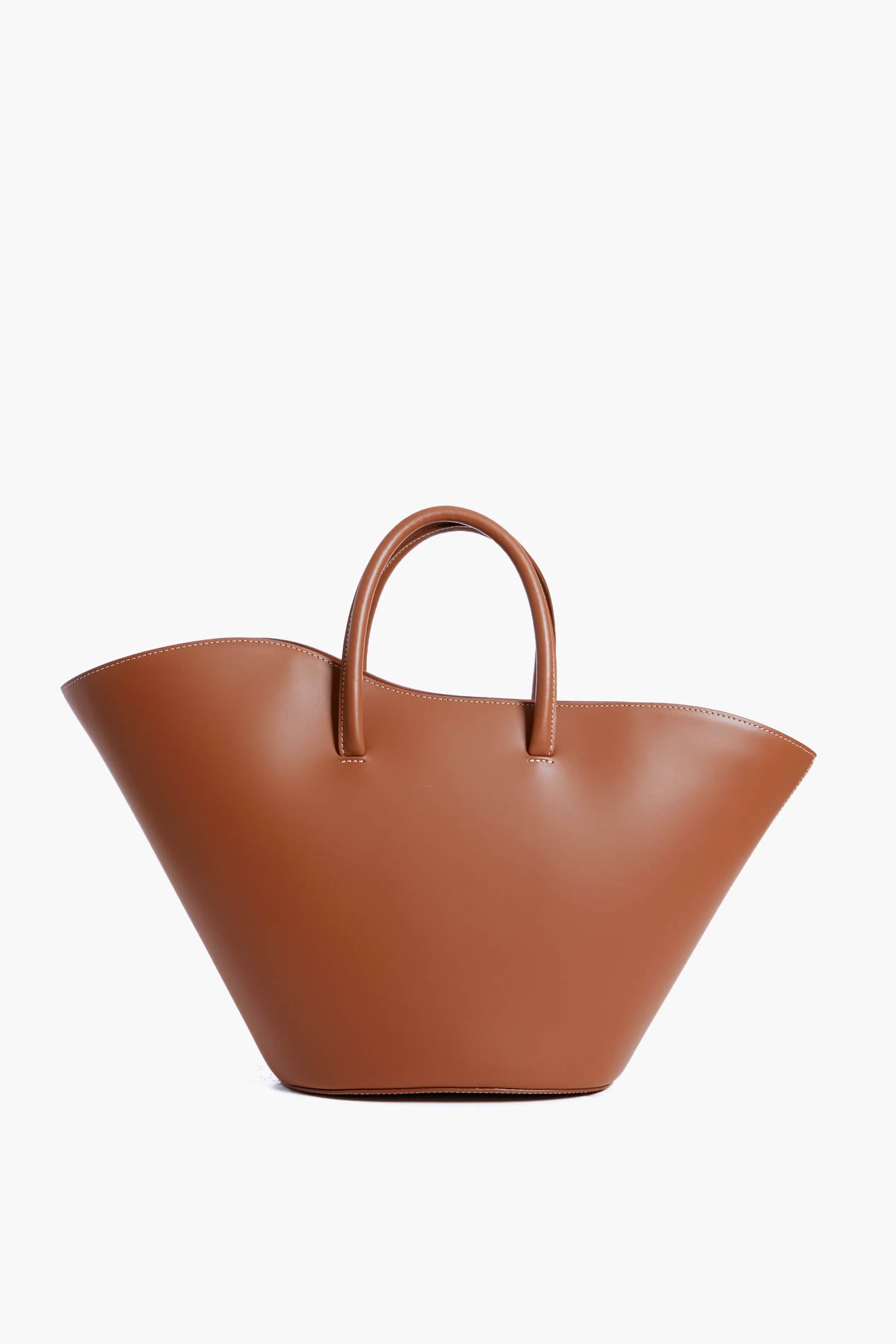 The Liffner structured brown leather handbag boasts Italian craftsmanship, a wide flared silhouette, and two short handles for a sophisticated look.