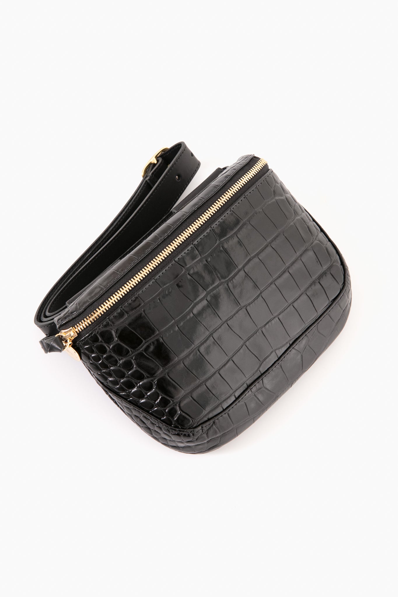 The Clare V black crocodile-printed leather crossbody bag features a gold zipper and adjustable strap, combining hands-free convenience with chic style.