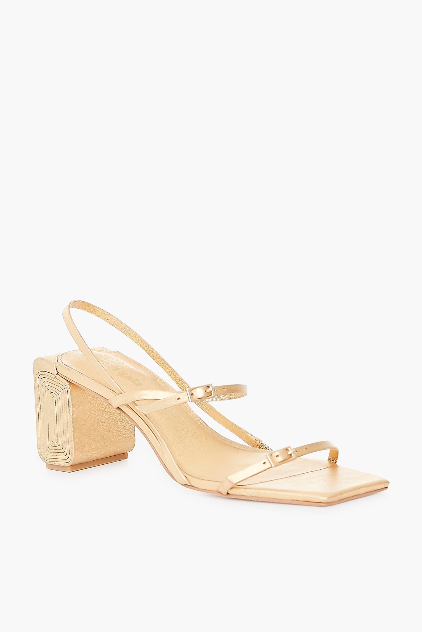 The Cult Gaia Maeve Sandal features two thin straps, a slingback strap, and a sculptural spiral block heel—all in an eye-catching gold finish.