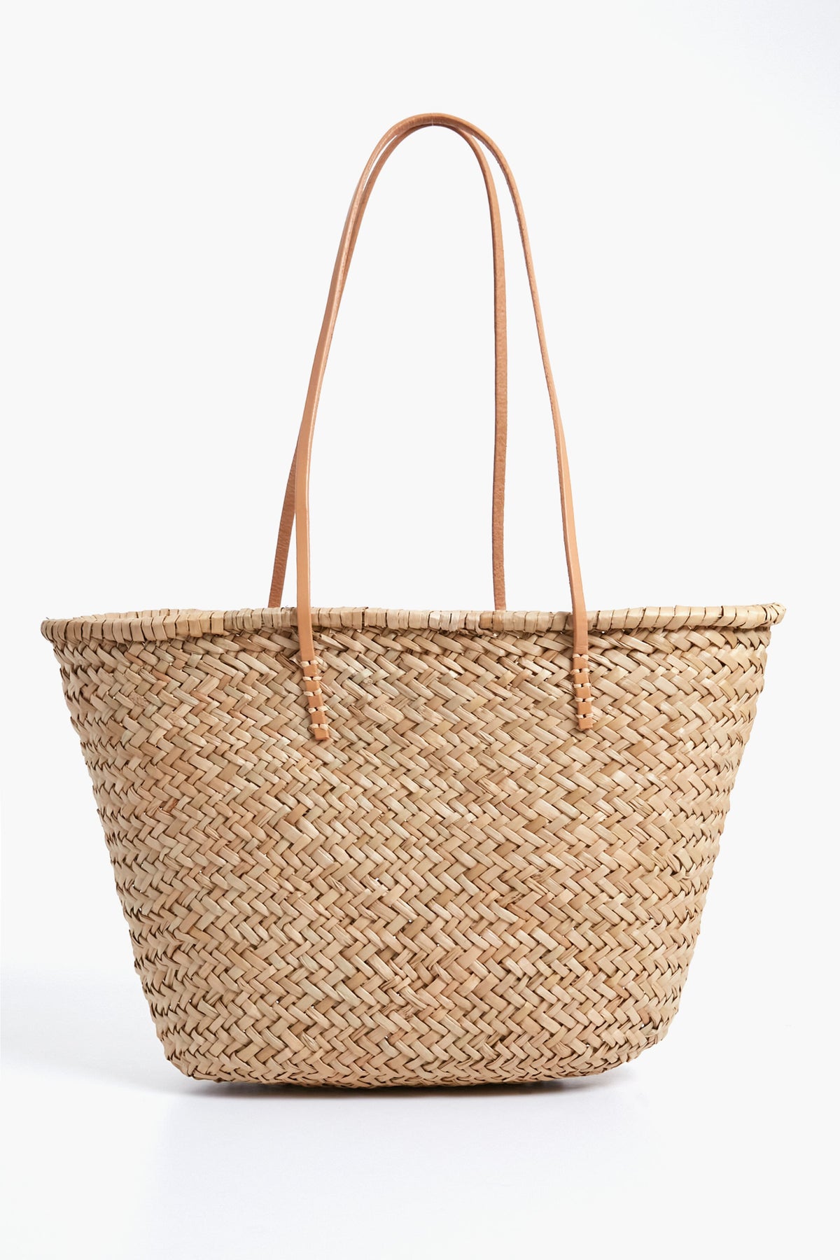 The Hat Attack Sorrento Tote is a woven straw bag with two long, thin leather handles—perfect for your next beach day.