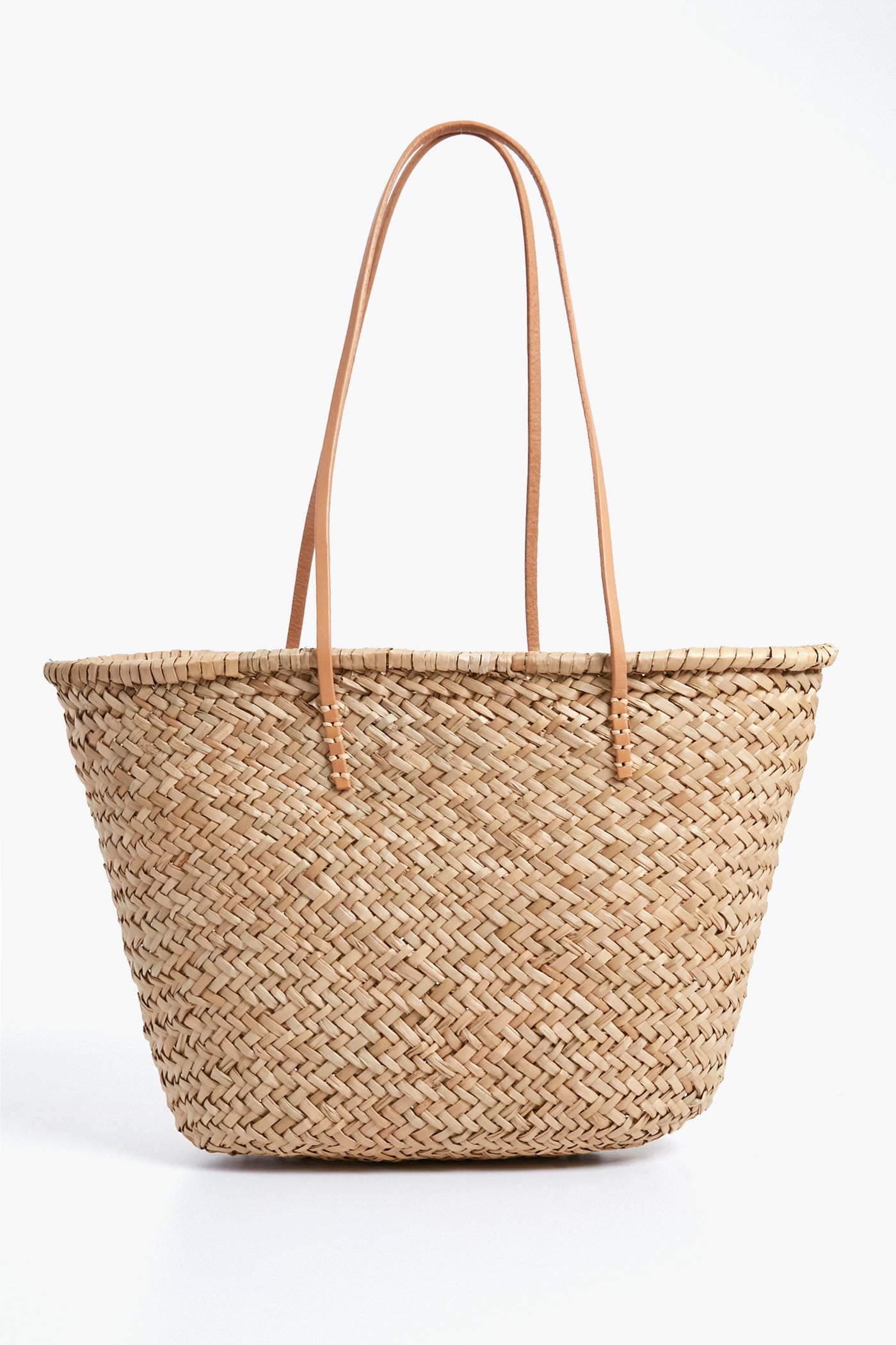 The Hat Attack Sorrento Tote is a woven straw bag with two long, thin leather handles—perfect for your next beach day.
