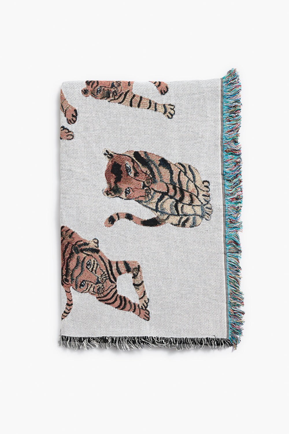 The Olivia Wendel Playful Tigers Blanket is a woven throw made from 100% US-grown cotton and features a charming tiger design.
