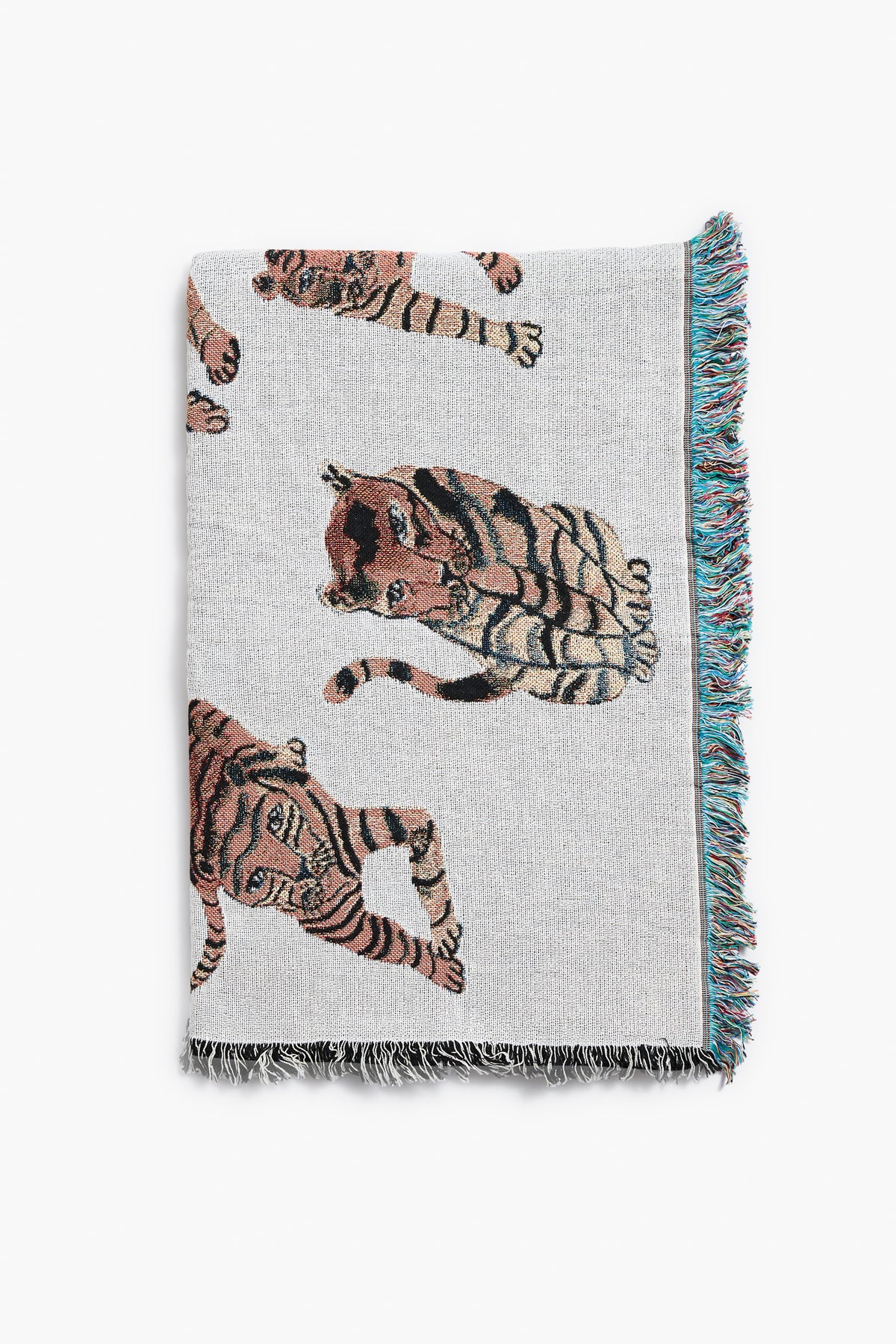 The Olivia Wendel Playful Tigers Blanket is a woven throw made from 100% US-grown cotton and features a charming tiger design.