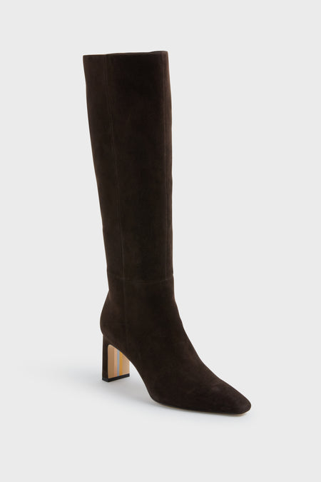 The Sam Edelman boot is a tall, chocolate brown suede knee-high style featuring a block heel and pointed toe.