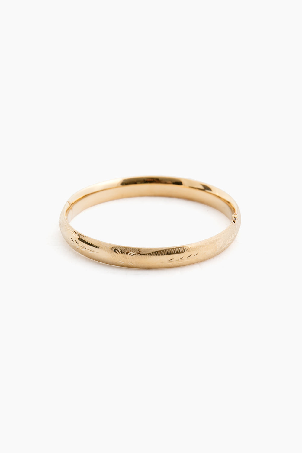 The RC Jewelry 14K yellow gold bangle features a smooth, slightly reflective surface and classic plain design.