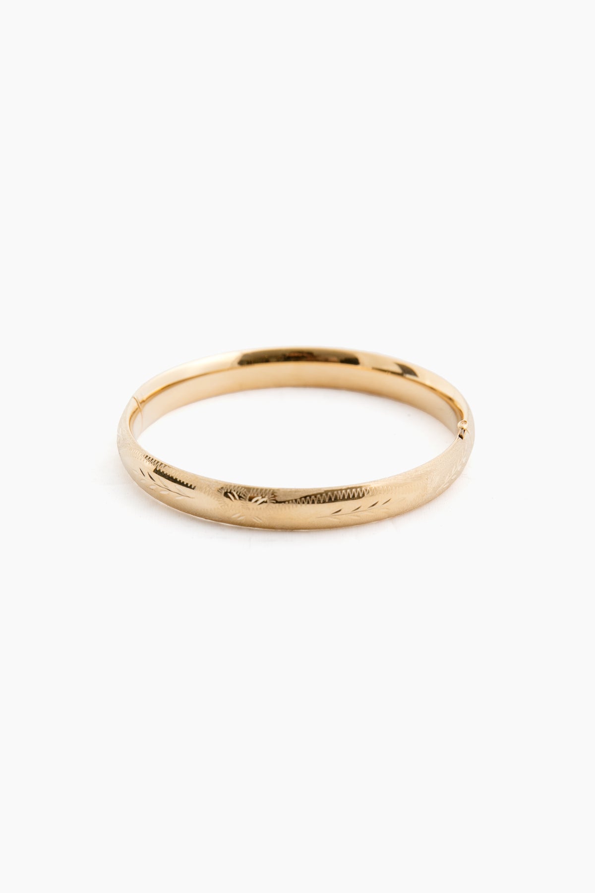 The RC Jewelry 14K yellow gold bangle features a smooth, slightly reflective surface and classic plain design.
