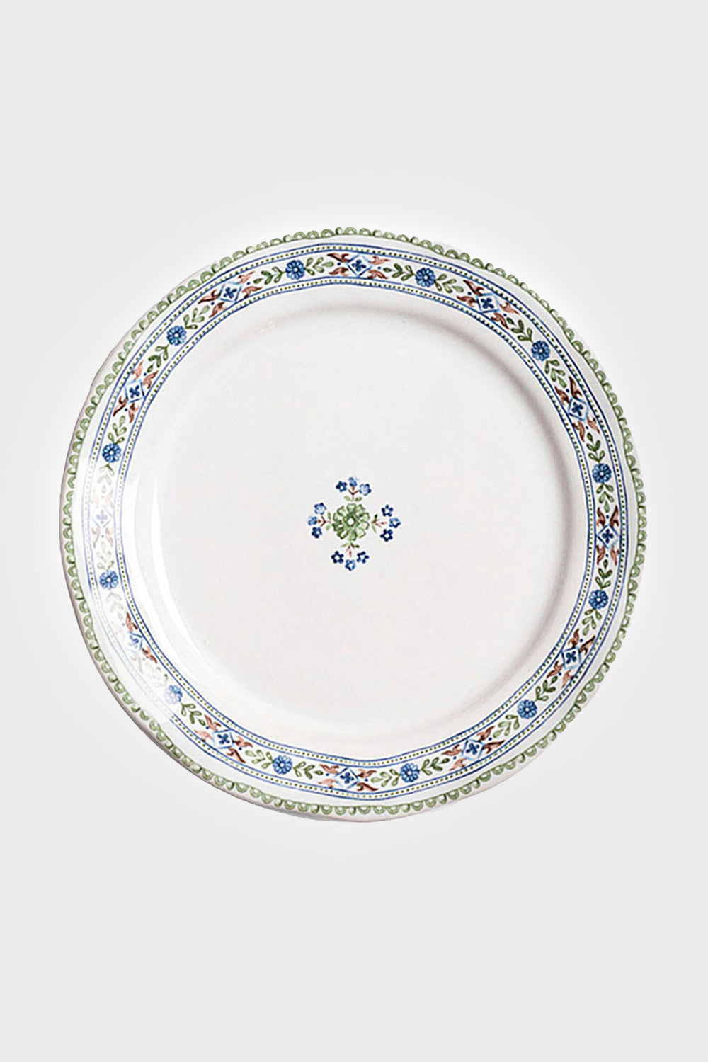 White ceramic salad plate from Juliska featuring a blue, green, and yellow floral rim and a small center motif. Dishwasher safe.