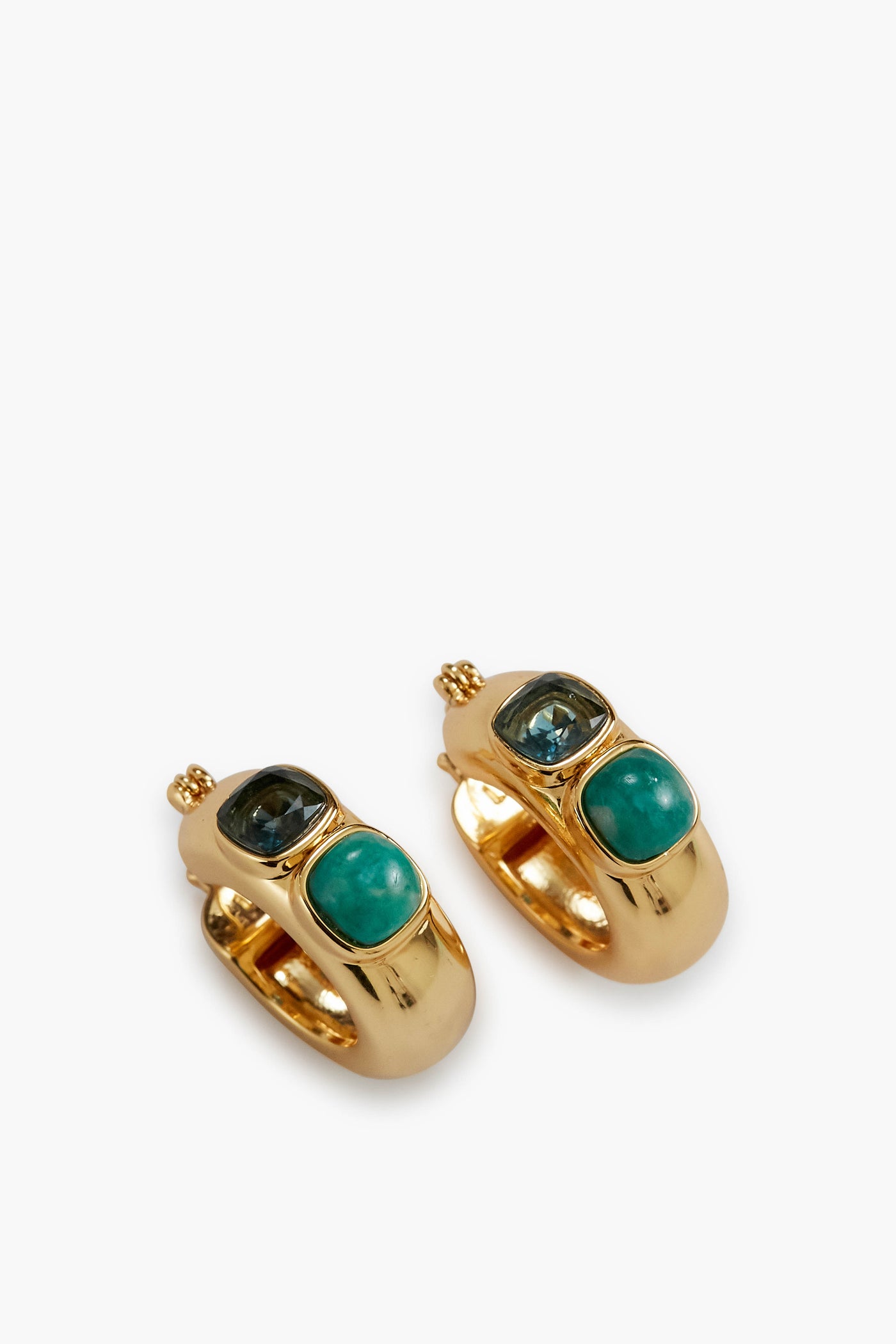 Gold-plated hoop earrings by Lizzie Fortunato, each featuring a geometric inlay with one green and one blue oval gemstone.