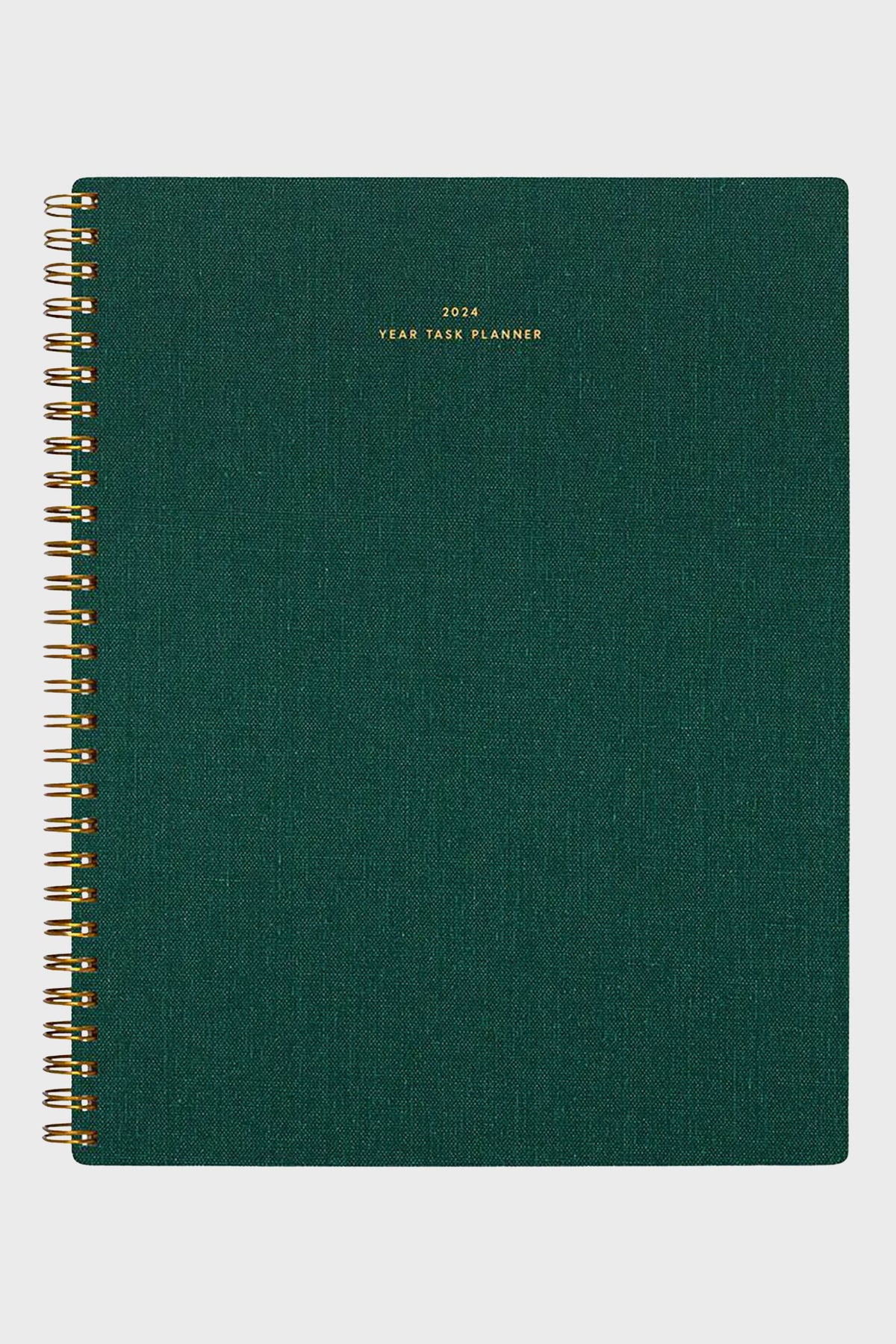 A 2024 yearly task planner from APPOINTED in hunter green with gold lettering on the cover and stylish spiral binding.