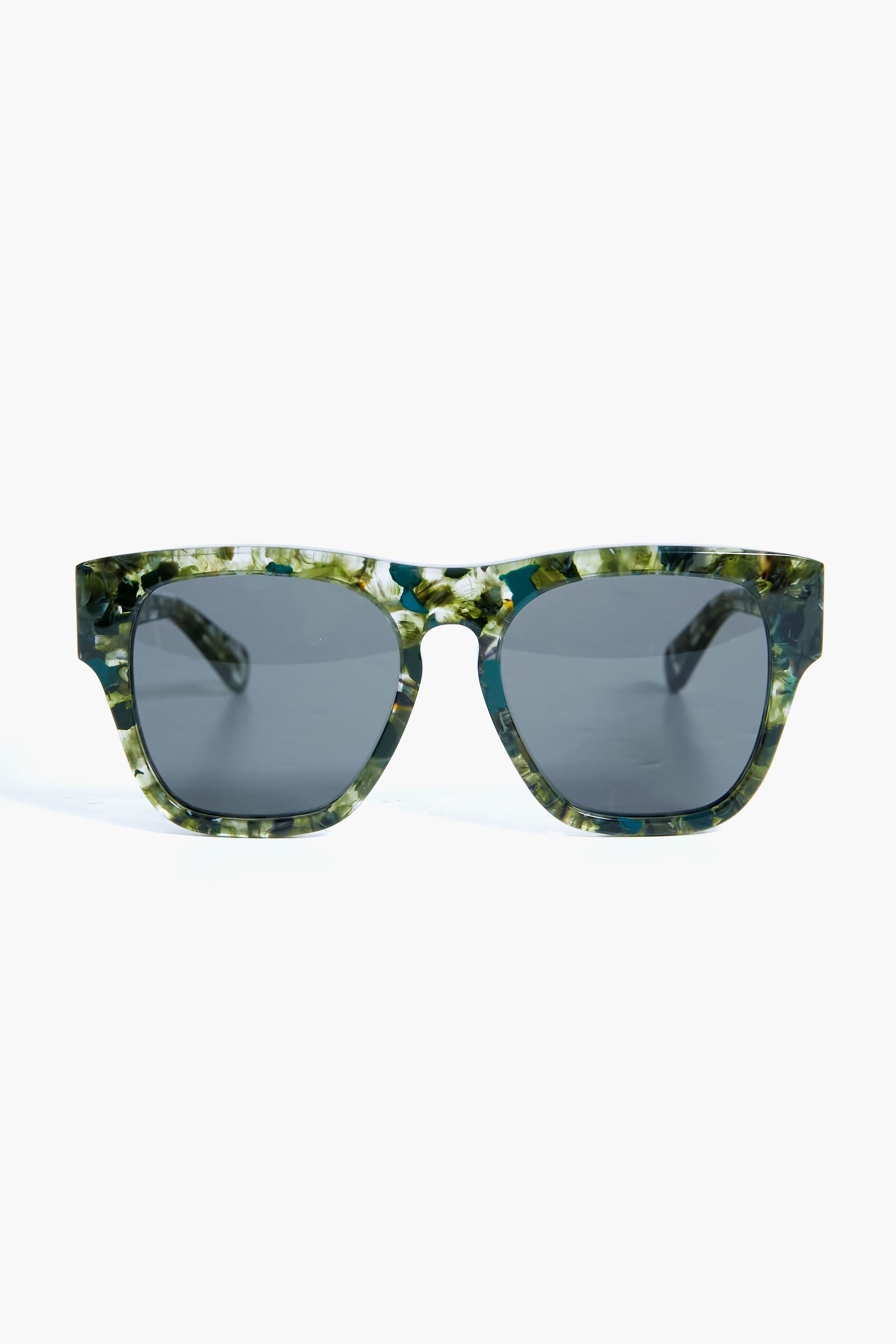 A pair of Chloe oversized square sunglasses with dark lenses and green marbled recycled acetate frames.