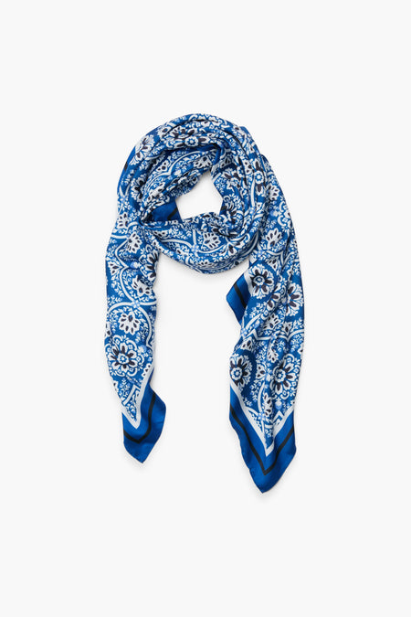 The Tuckernuck Accessories Navy Medallion Scarf, featuring blue and white floral and geometric patterns, is displayed to showcase its timeless classic style.