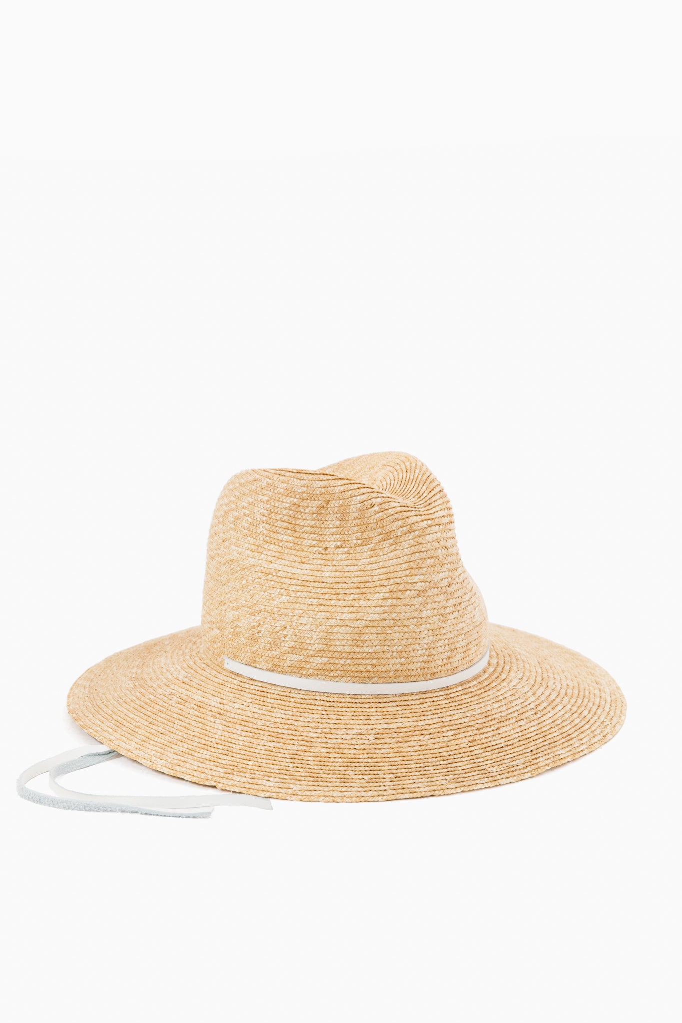 The Lola Hats wide-brimmed wheat straw hat features a classic white ribbon band and matching tie, blending timeless style with sun protection.