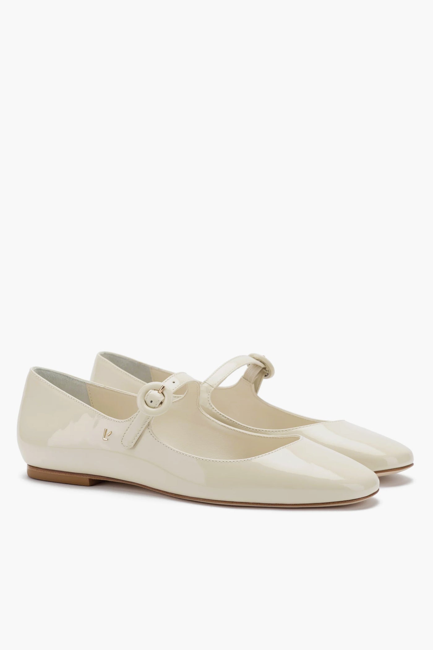 A pair of Larroude glossy beige Ivory Blair Ballet Flats in classic mary jane style, featuring a rounded toe, low heel, thin strap with round buckle, and memory foam cushioned insole for comfort.
