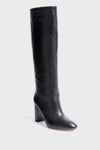 A single black Loeffler Randall knee-high leather boot is shown, featuring a rounded toe and block heel.