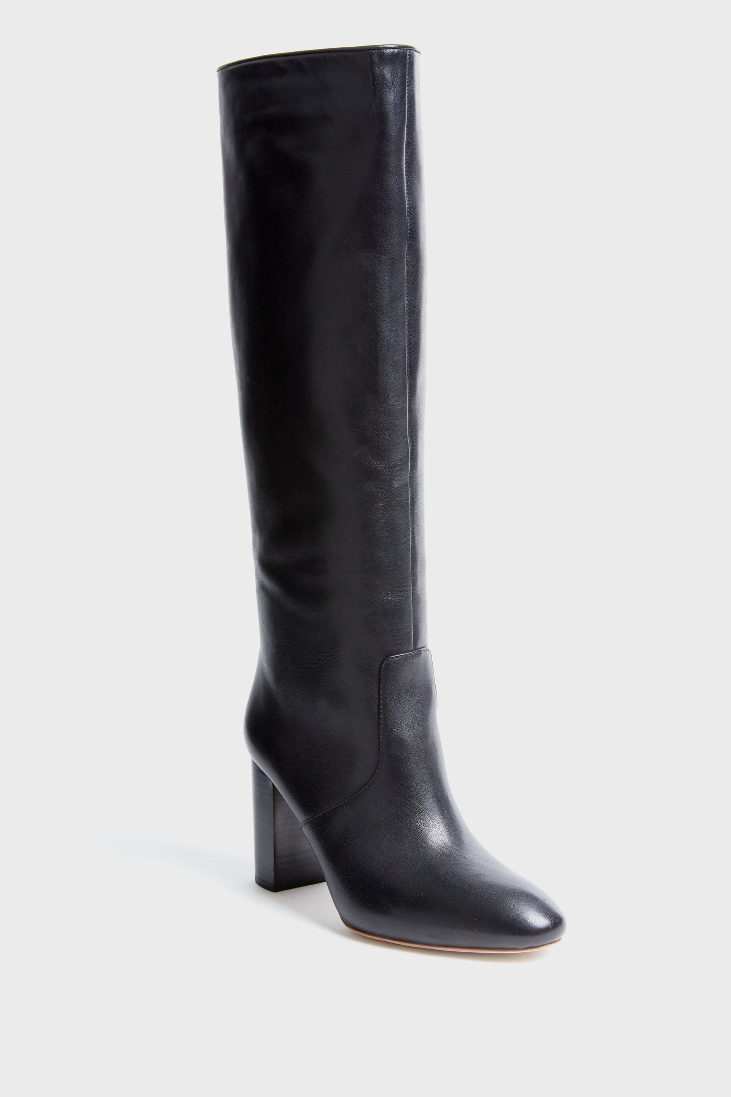 A single black Loeffler Randall knee-high leather boot is shown, featuring a rounded toe and block heel.