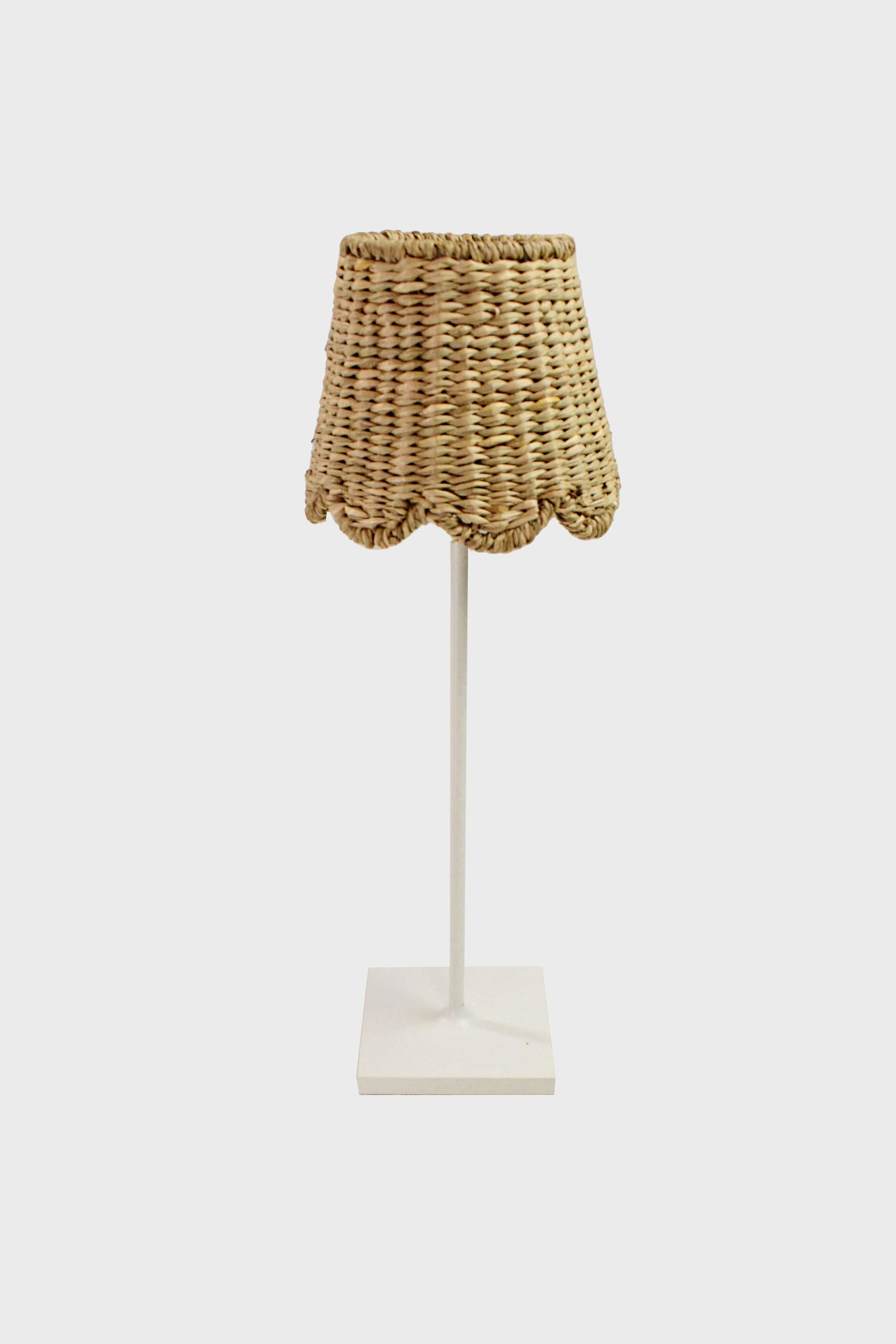 Maison Maison Design table lamp with a white stand and base, topped with a seagrass scalloped lampshade—a charming choice for fans of handmade home decor and French antiques.