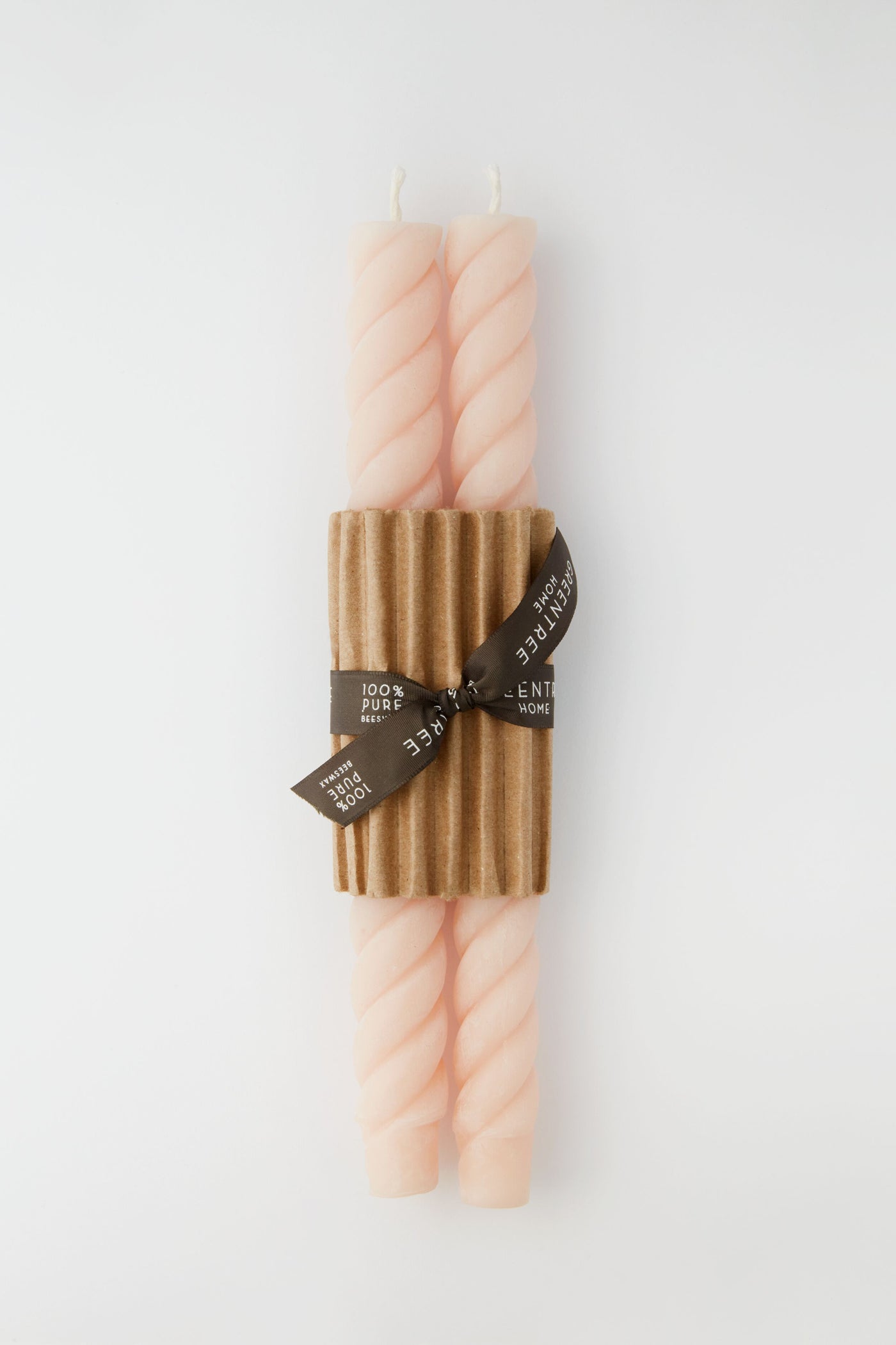 Greentree Home’s elegant set includes two pale pink hand-poured beeswax tapers, bundled with a corrugated cardboard sleeve and brown ribbon—a thoughtful housewarming gift.