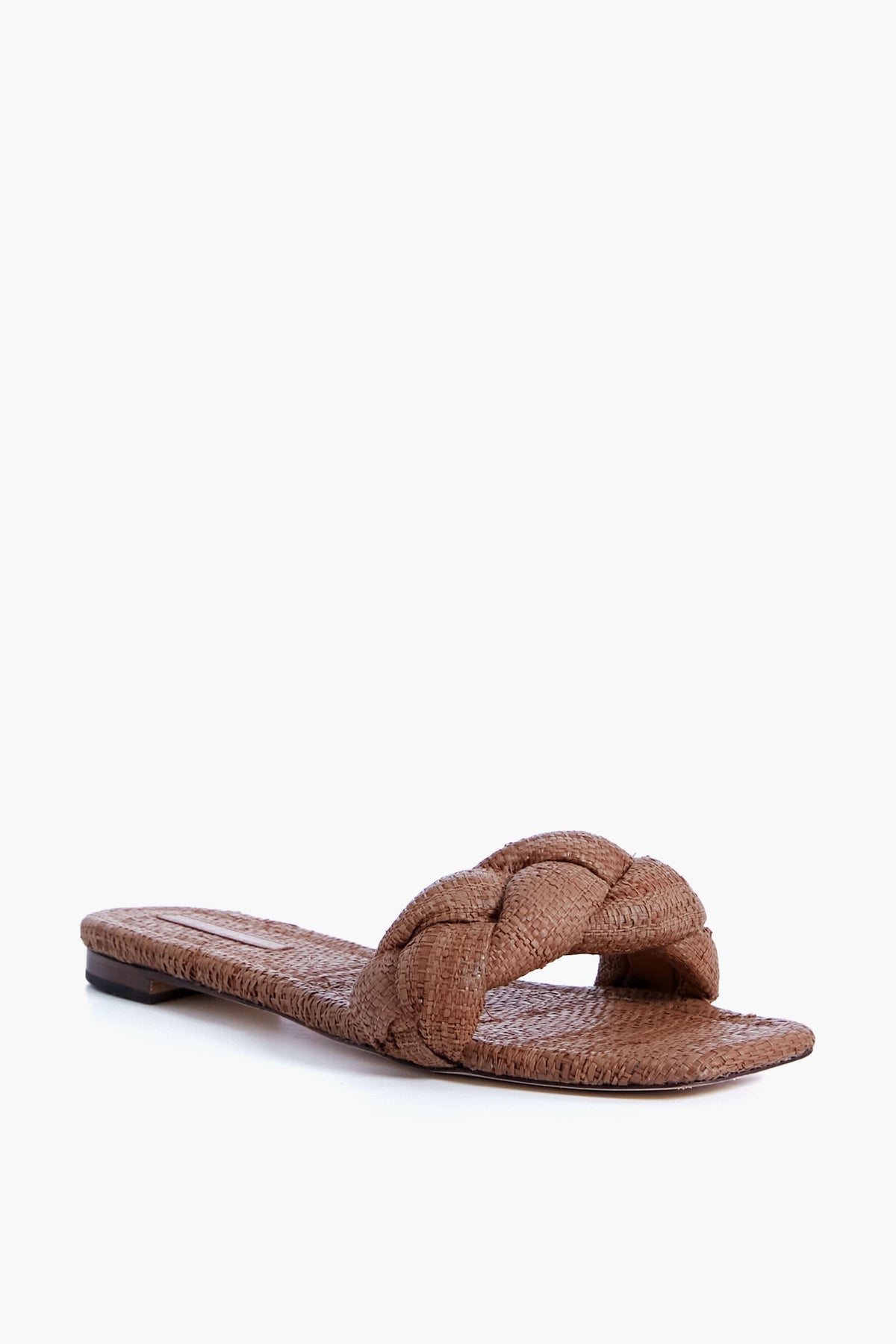 Loeffler Randall Joanna Band Flat Sandal in brown features a single braided toe strap, open toe design, and flat sole, all crafted from natural raffia.