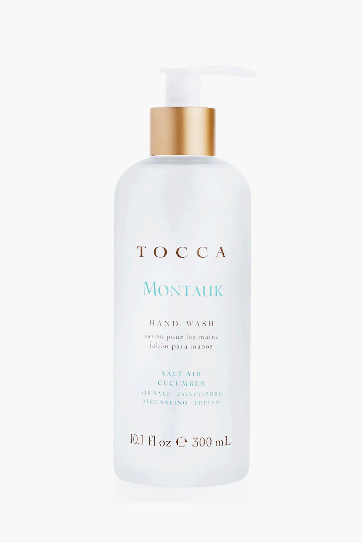 Tocca Montauk Hand Wash (10.1 fl oz) is a natural hand soap in a clear bottle with a gold pump, featuring a salt air cucumber scent for a luxurious touch.
