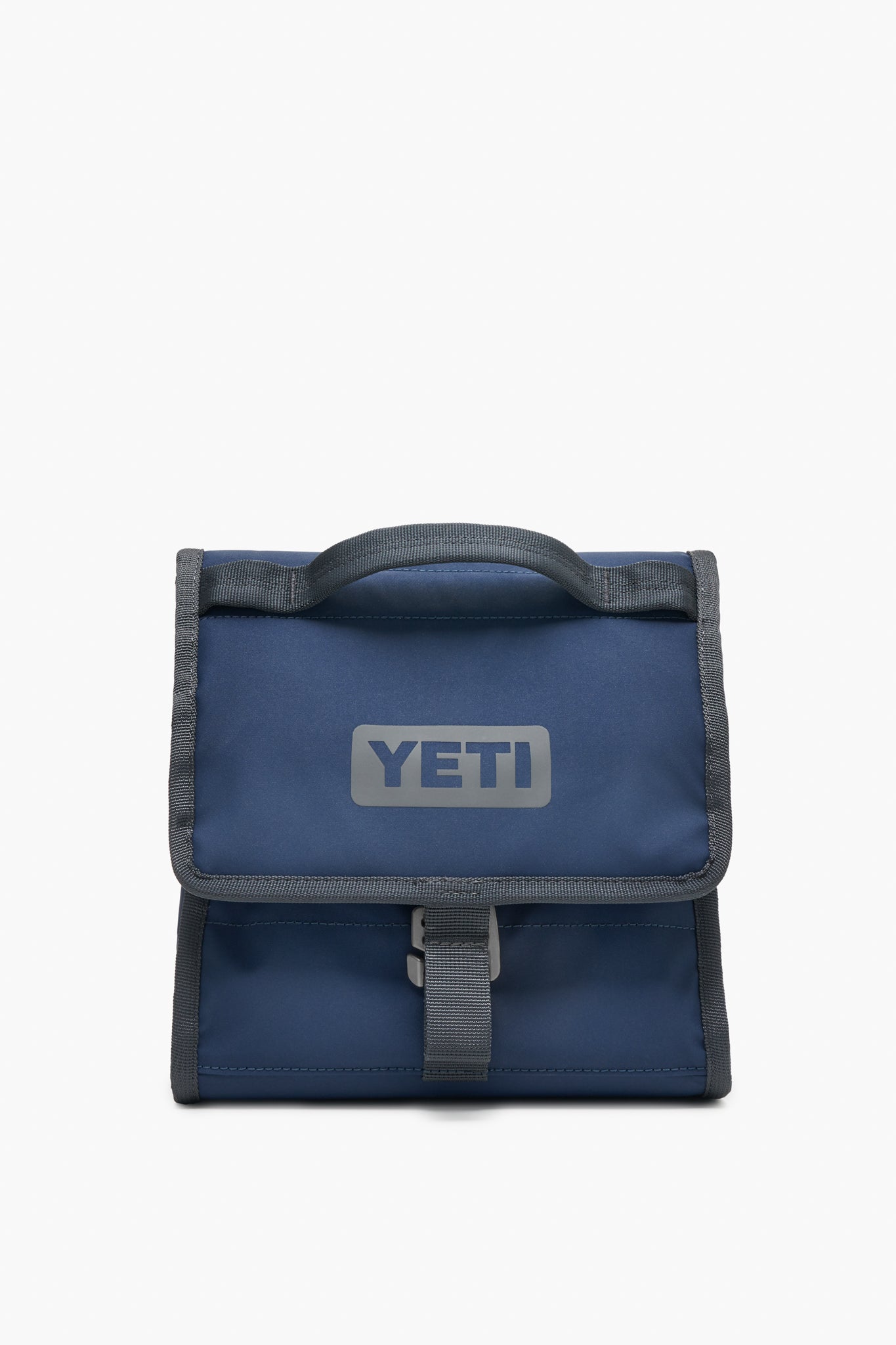 A blue YETI insulated lunch bag with a gray handle and trim, YETI logo on the front, and buckle closure—durable and perfect as an outdoor cooler.