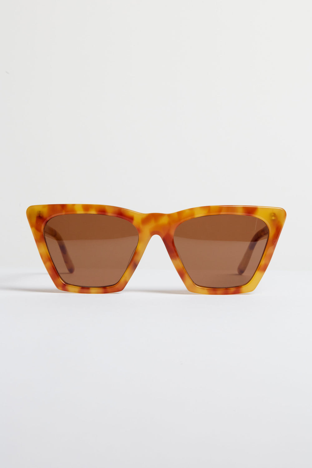 A pair of angular tortoise-frame sunglasses with brown lenses—the Amber Lisbon Sunglasses by Illesteva showcase handmade Italian craftsmanship.