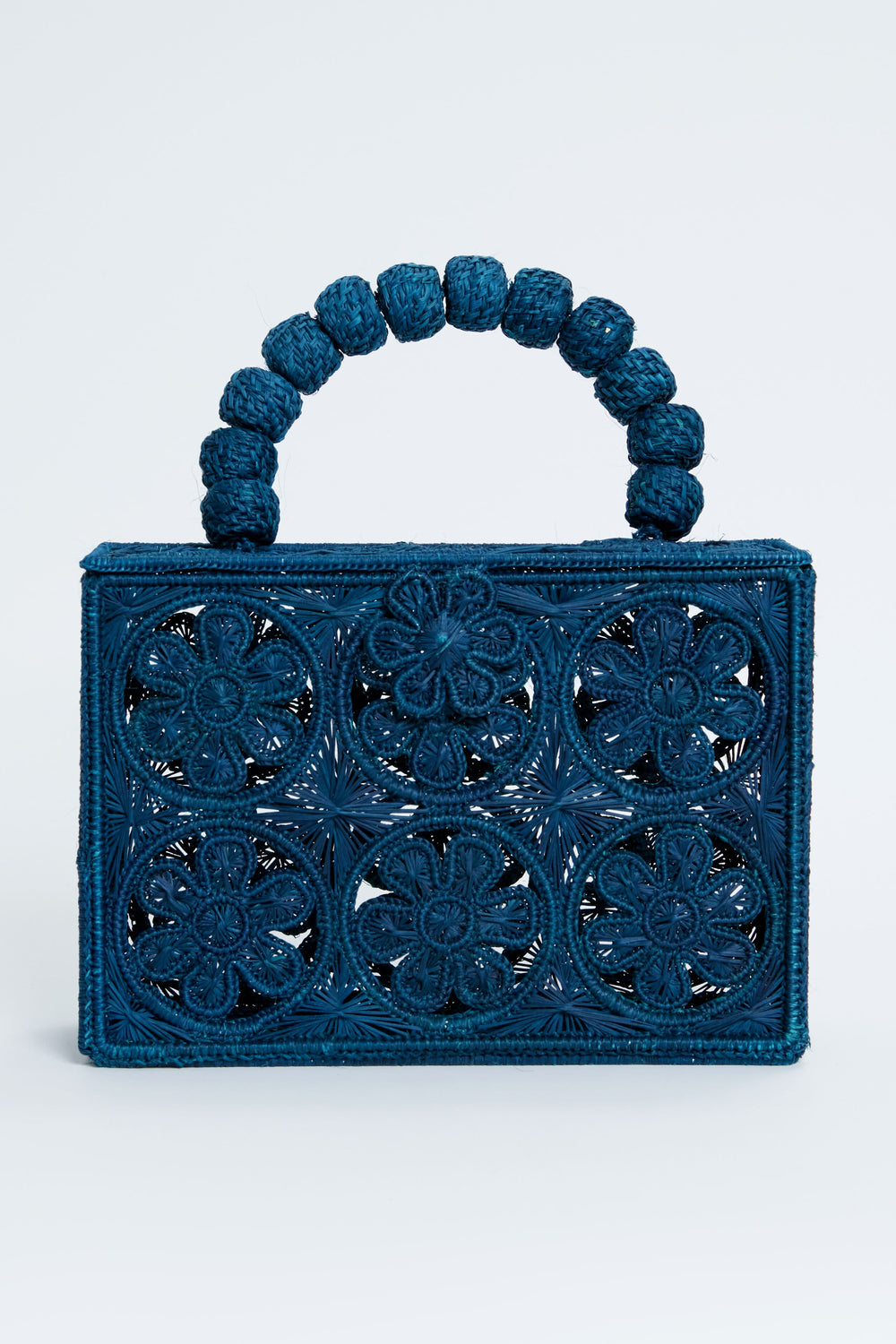 ASHA x Tuckernuck rectangular blue floral clutch with intricate cutout pattern and a handle of large woven beads—perfect for the beach.
