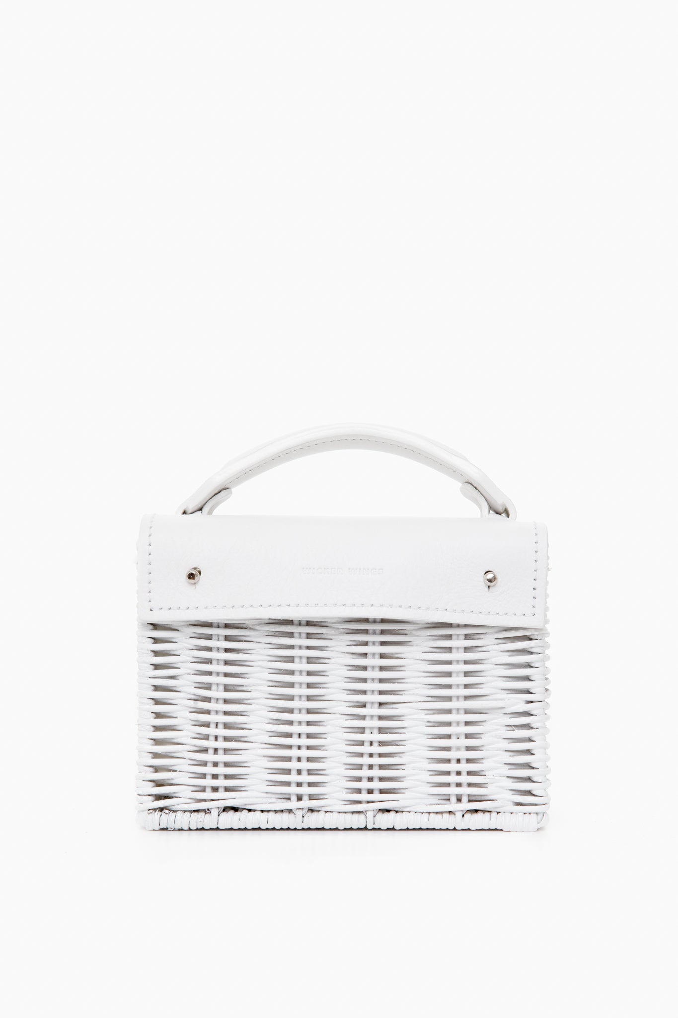 A handmade small white woven bag by Wicker Wings, crafted from sustainable materials with a short top handle and silver hardware.