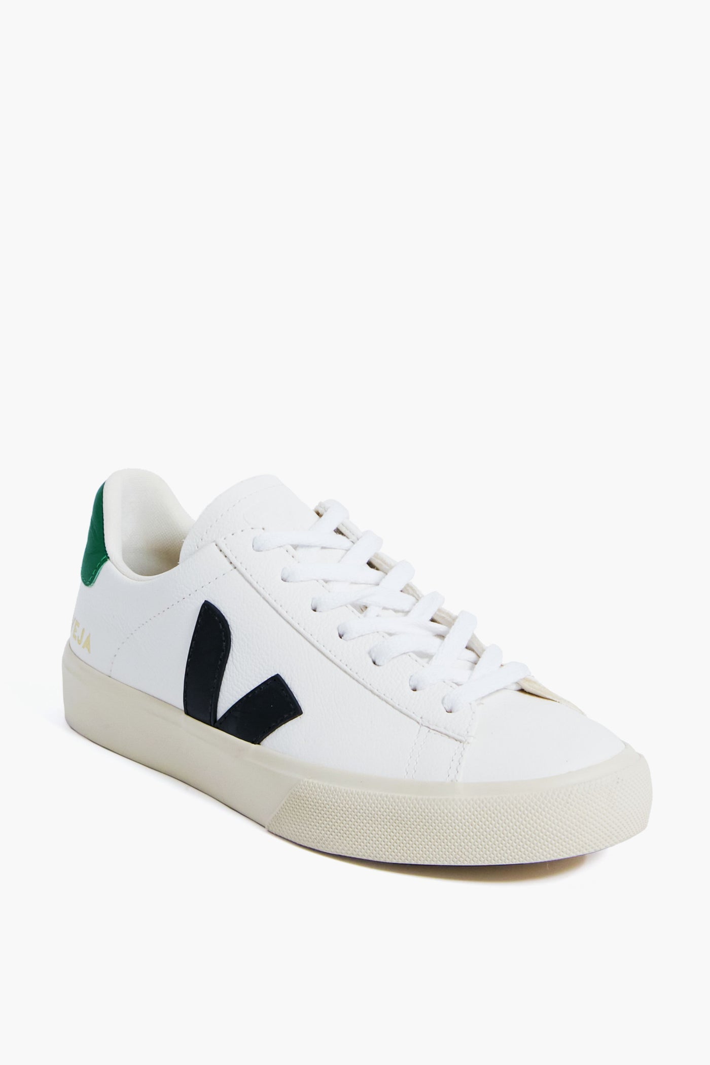 The VEJA white low-top sneaker is crafted from ecological materials, featuring a black V logo, green heel detail, and white laces—a stylish, sustainable choice.