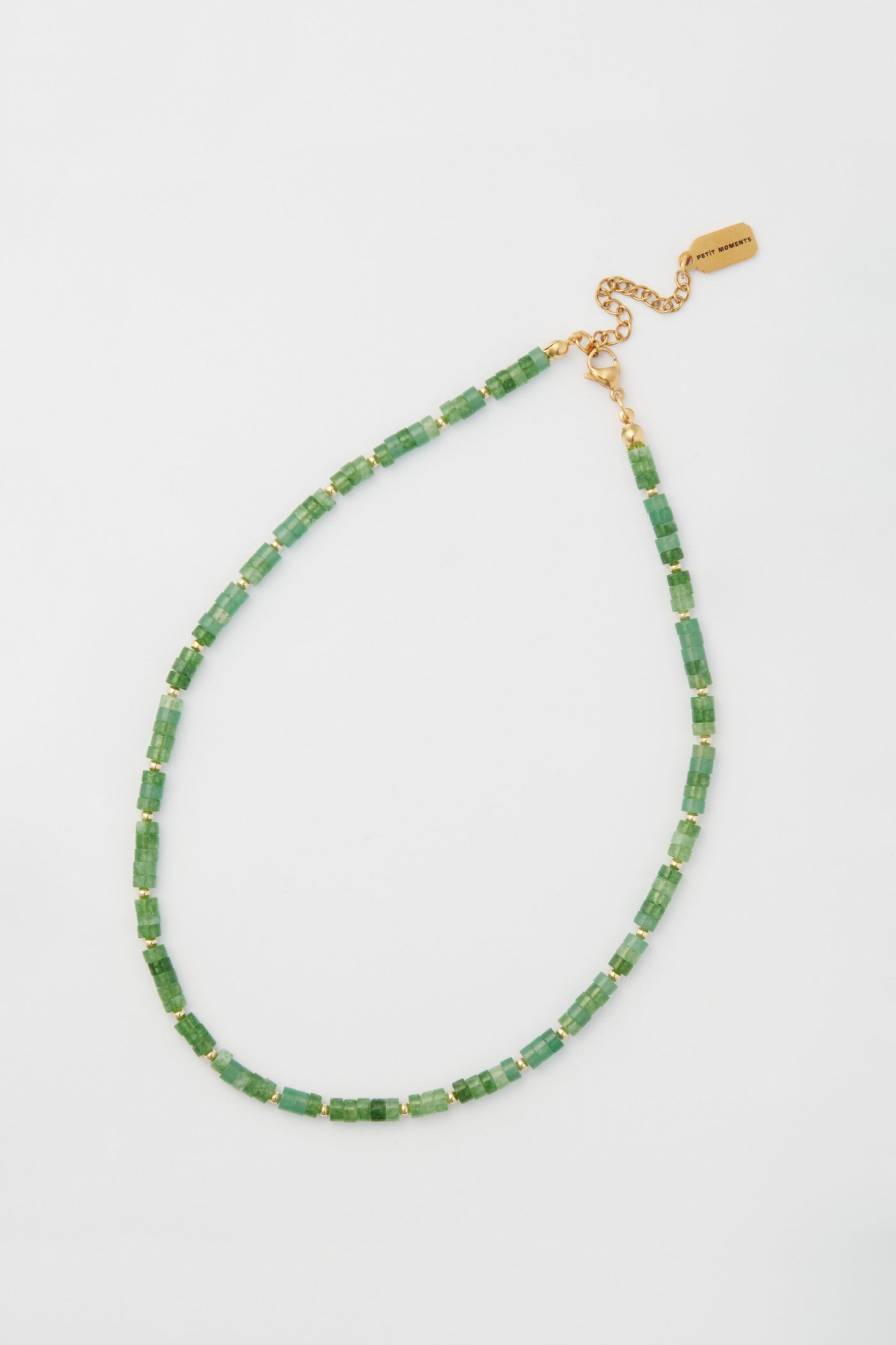 The Green Luke Necklace by Petit Moments features jade beads, gold-plated spacers, and an adjustable gold chain clasp.