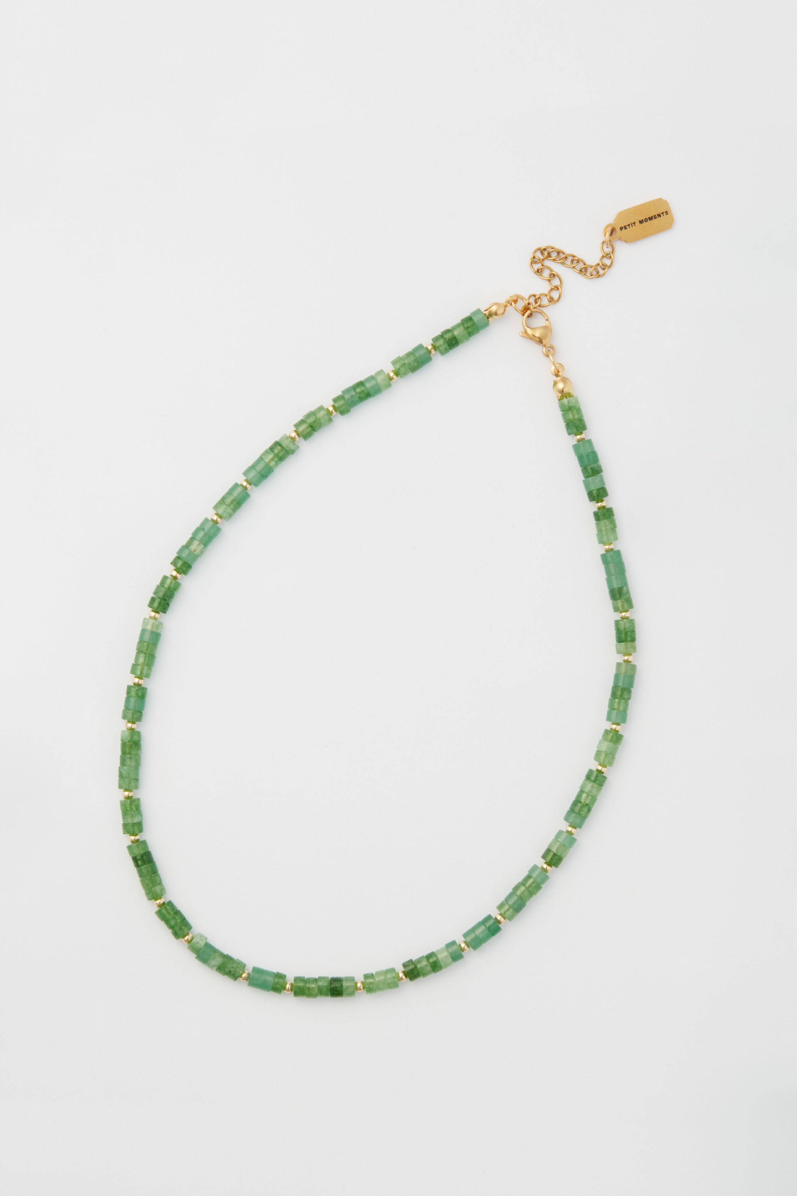The Green Luke Necklace by Petit Moments features jade beads, gold-plated spacers, and an adjustable gold chain clasp.