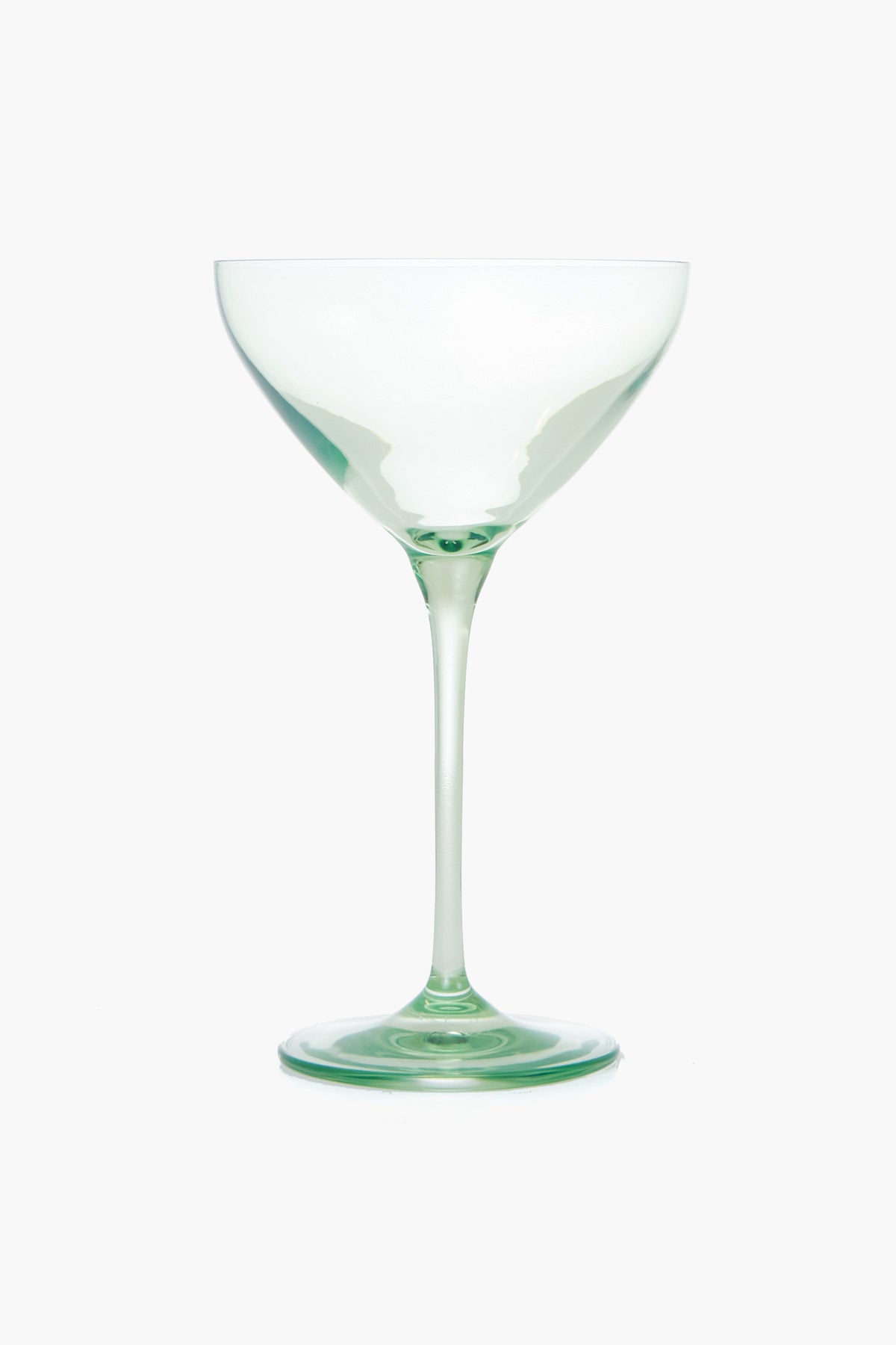 A clear, empty cocktail glass from Estelle Colored Glass with a long stem and wide, shallow bowl—beautiful hand-blown stemware perfect as a luxury hostess gift.