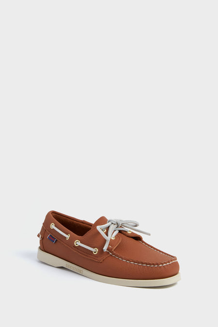 A single SEBAGO brown leather boat shoe with white stitching, a white sole, and light-colored laces, reflecting classic nautical footwear style.