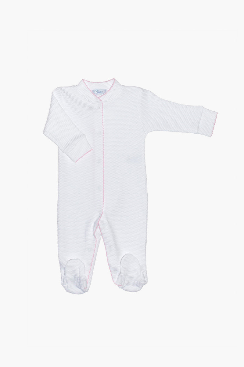 Nella Pima white baby onesie with long sleeves, covered feet, and snap buttons down the front. Features soft pink trim and is made from luxurious Peruvian Pima cotton—perfect as cozy baby footie pajamas.