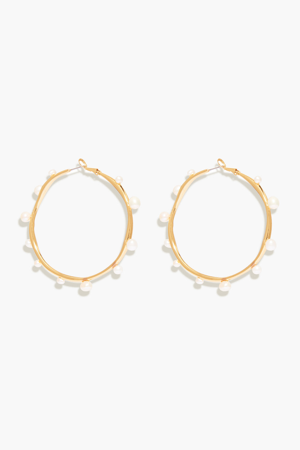 Mignonne Gavigan's Isla Pearl Hoops are gold-plated earrings accented with small, evenly spaced freshwater pearls around each hoop.