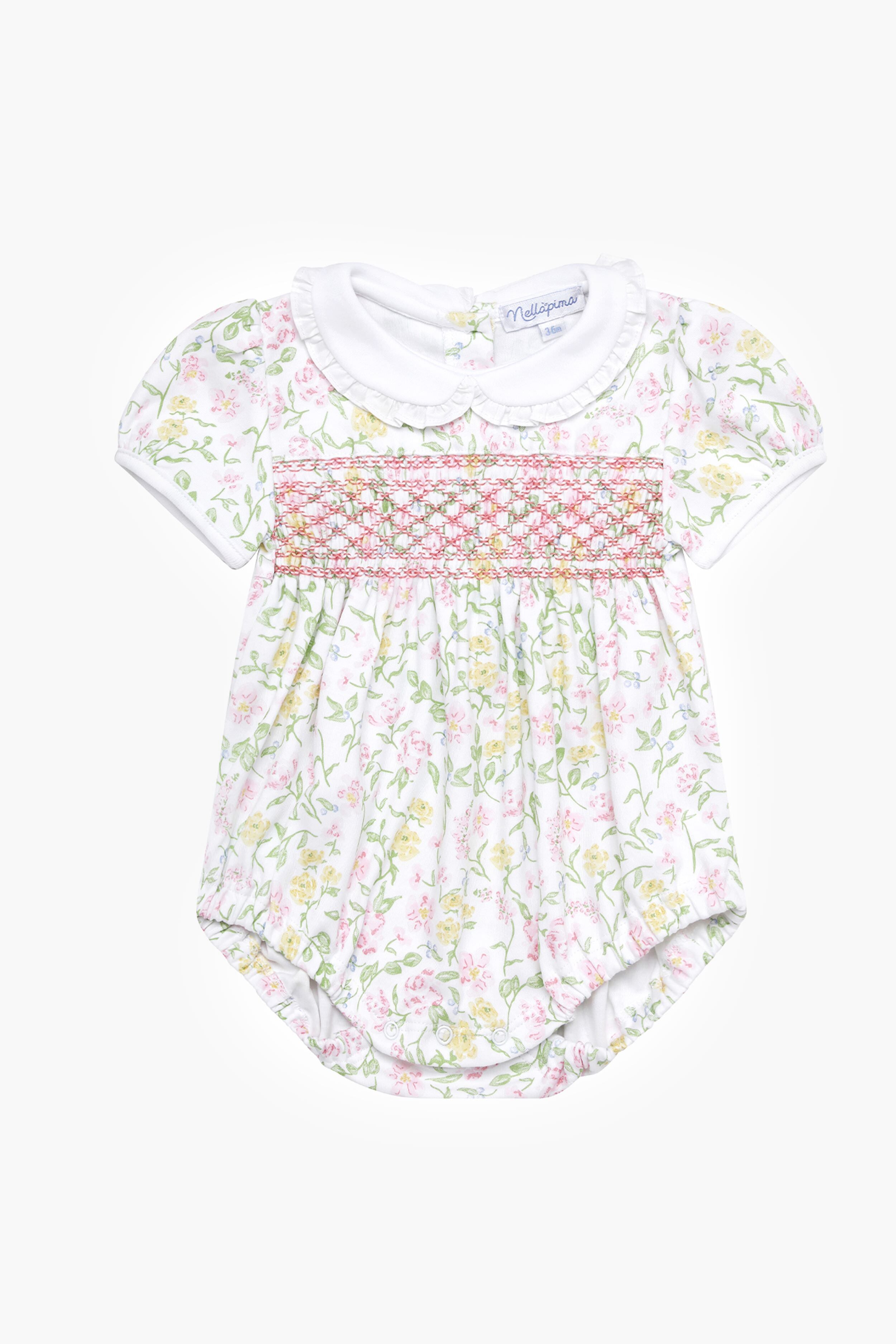 Nella Pima baby romper made from soft Peruvian Pima cotton, with short sleeves, white Peter Pan collar, floral print, and smocked chest—an adorable smocked bubble onesie.