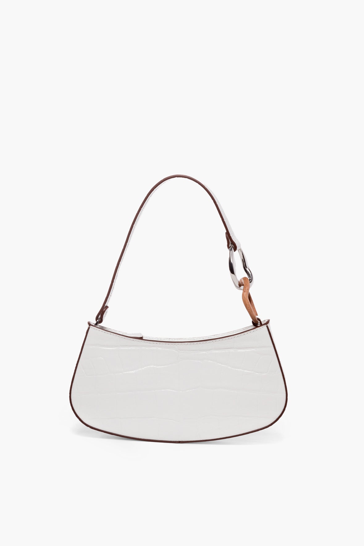 A white, crescent-shaped STAUD Ollie shoulder bag crafted from croc-effect leather with a textured surface and a single shoulder strap.