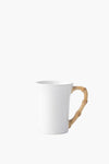 Juliska white ceramic stoneware mug featuring a curved, light brown bamboo-style handle from the Bamboo collection.