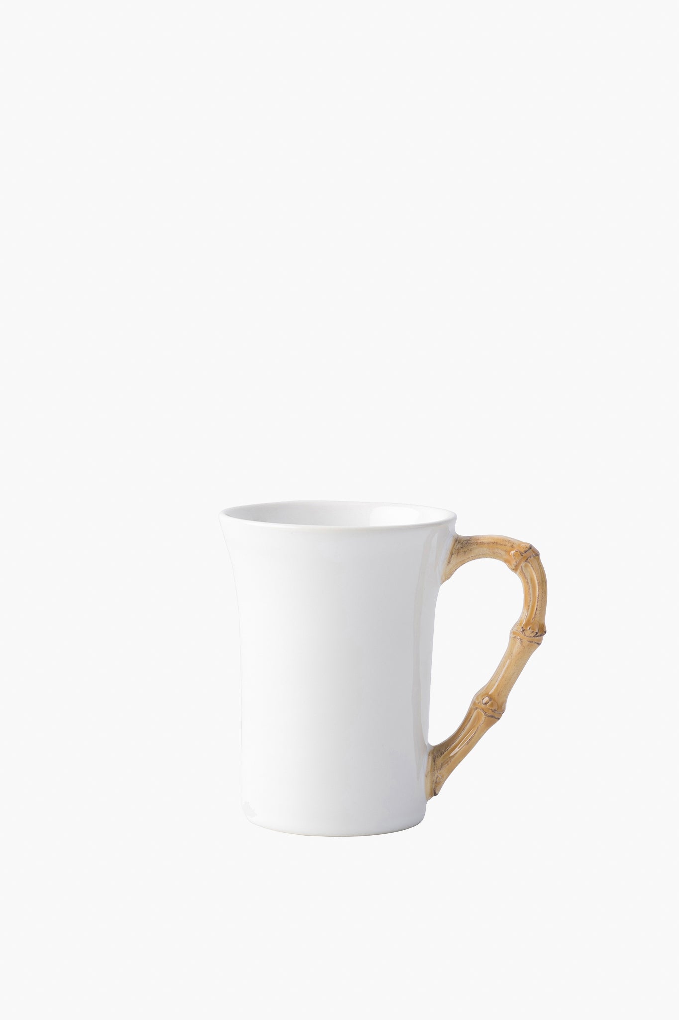 Juliska white ceramic stoneware mug featuring a curved, light brown bamboo-style handle from the Bamboo collection.