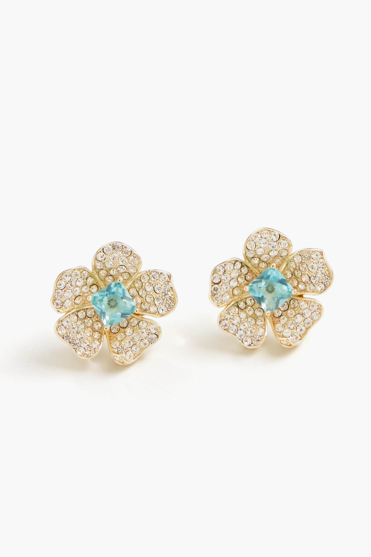 Nicola Bathie gold flower studs feature petals encrusted with small clear stones and a London Blue gemstone at the center, crafted in a 14k gold-plated finish.