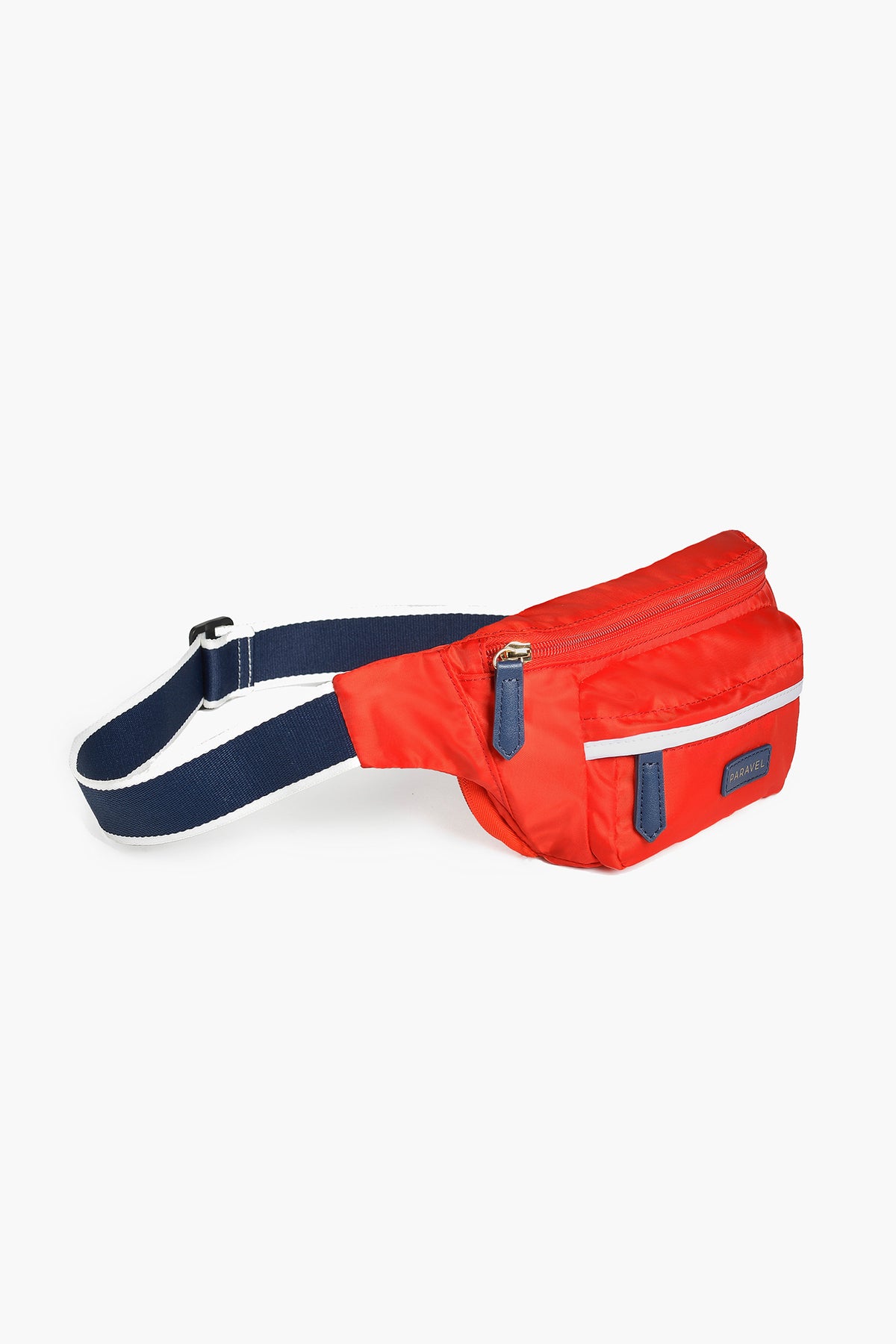 The Paravel red belt bag features a navy adjustable strap, front zip pocket, and dark blue zipper pulls—ideal for hands-free adventures.