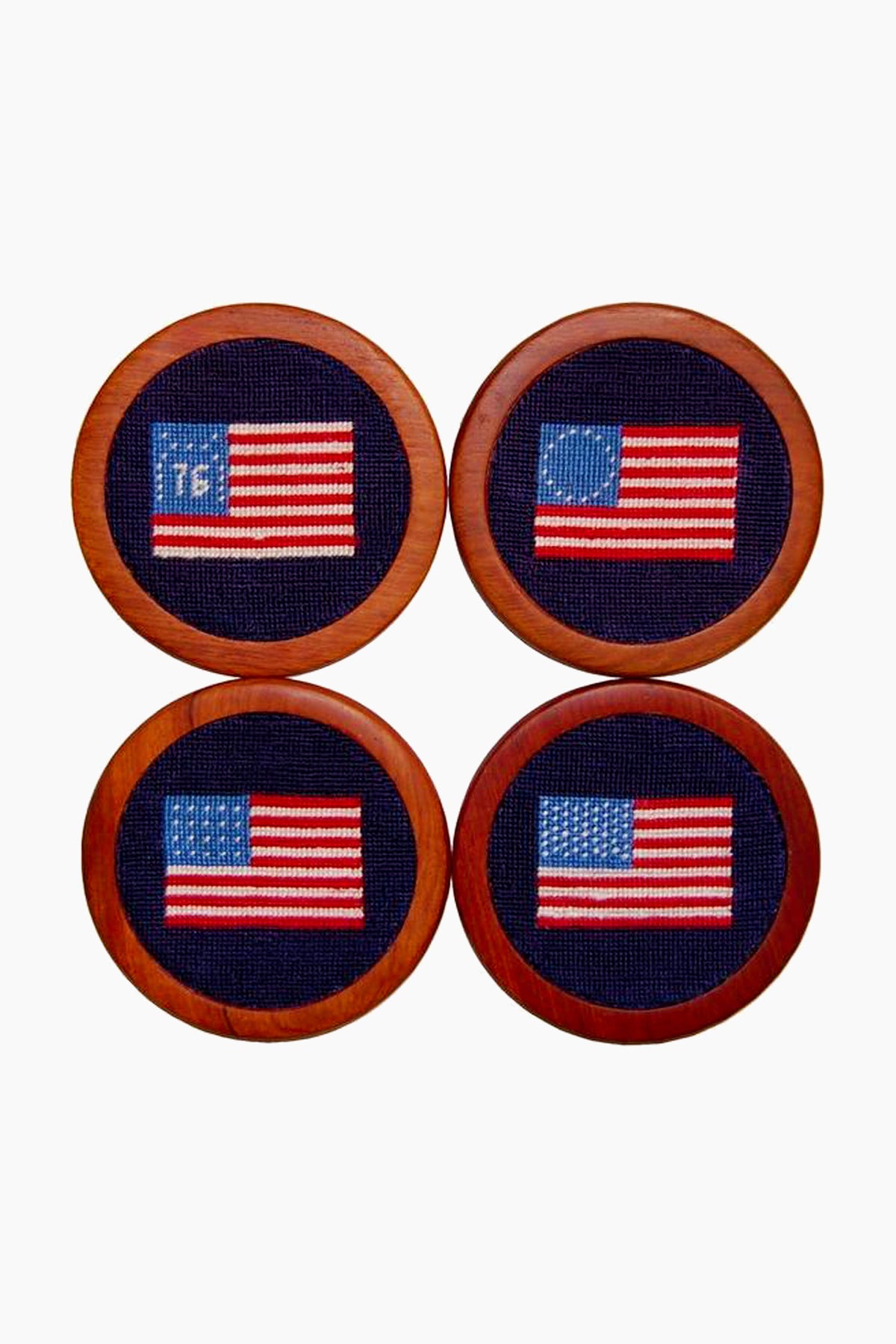 Four hand-stitched coasters by Smathers and Branson, each featuring a unique historical or modern American flag design, are displayed in a 2x2 grid.