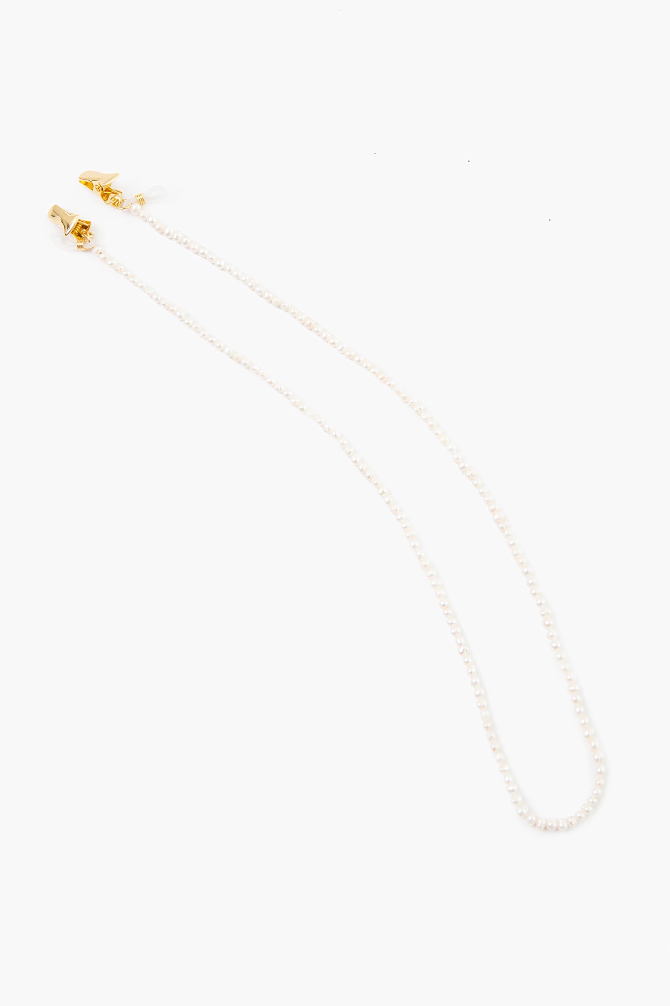The Tuckernuck Accessories beaded eyeglass or sunglass chain features small white pearls and gold clasps on each end, offering a touch of elegance to your look.