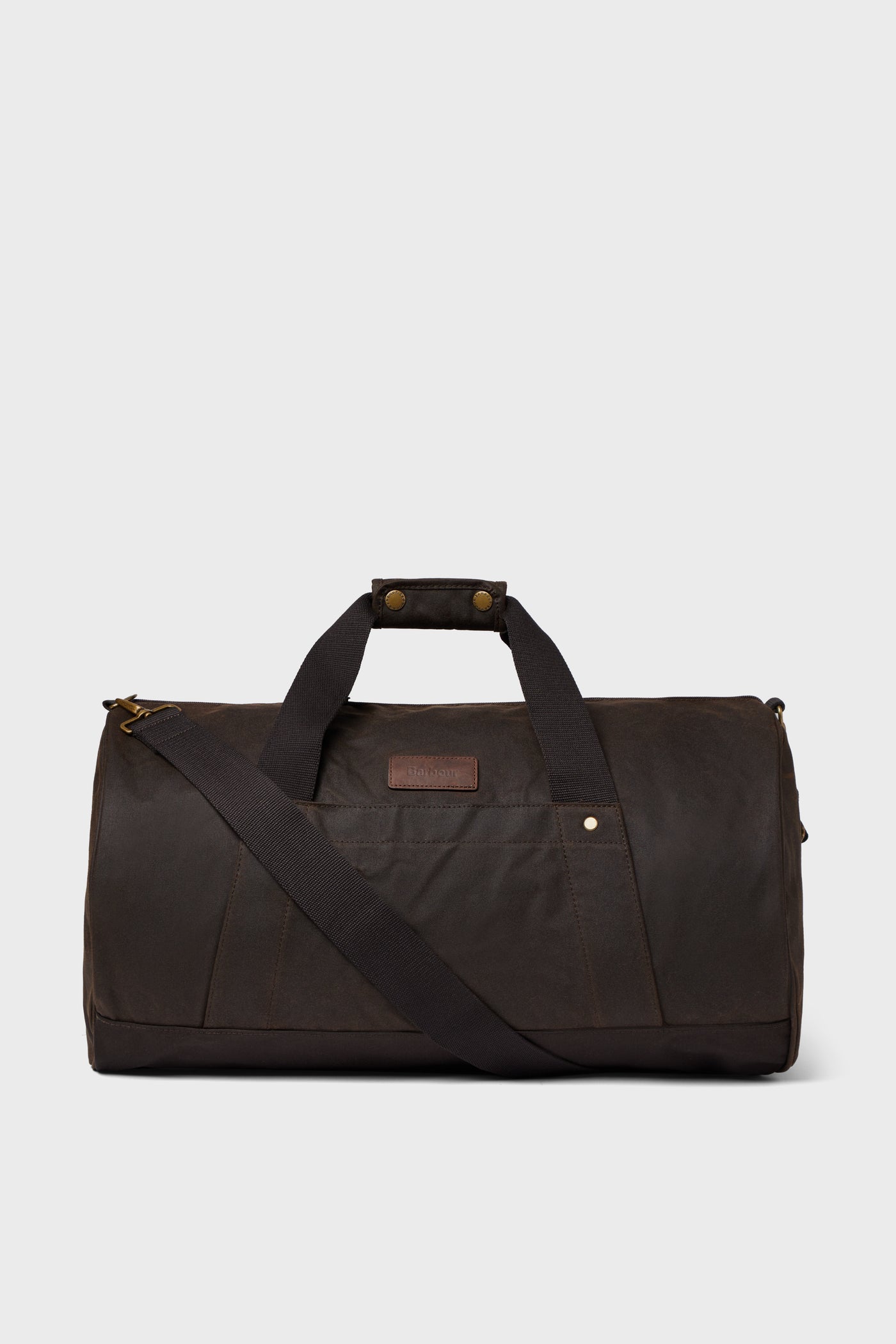 A Barbour duffle bag in dark brown featuring dual handles, a detachable shoulder strap, and a front pocket—ideal for weekend getaways.