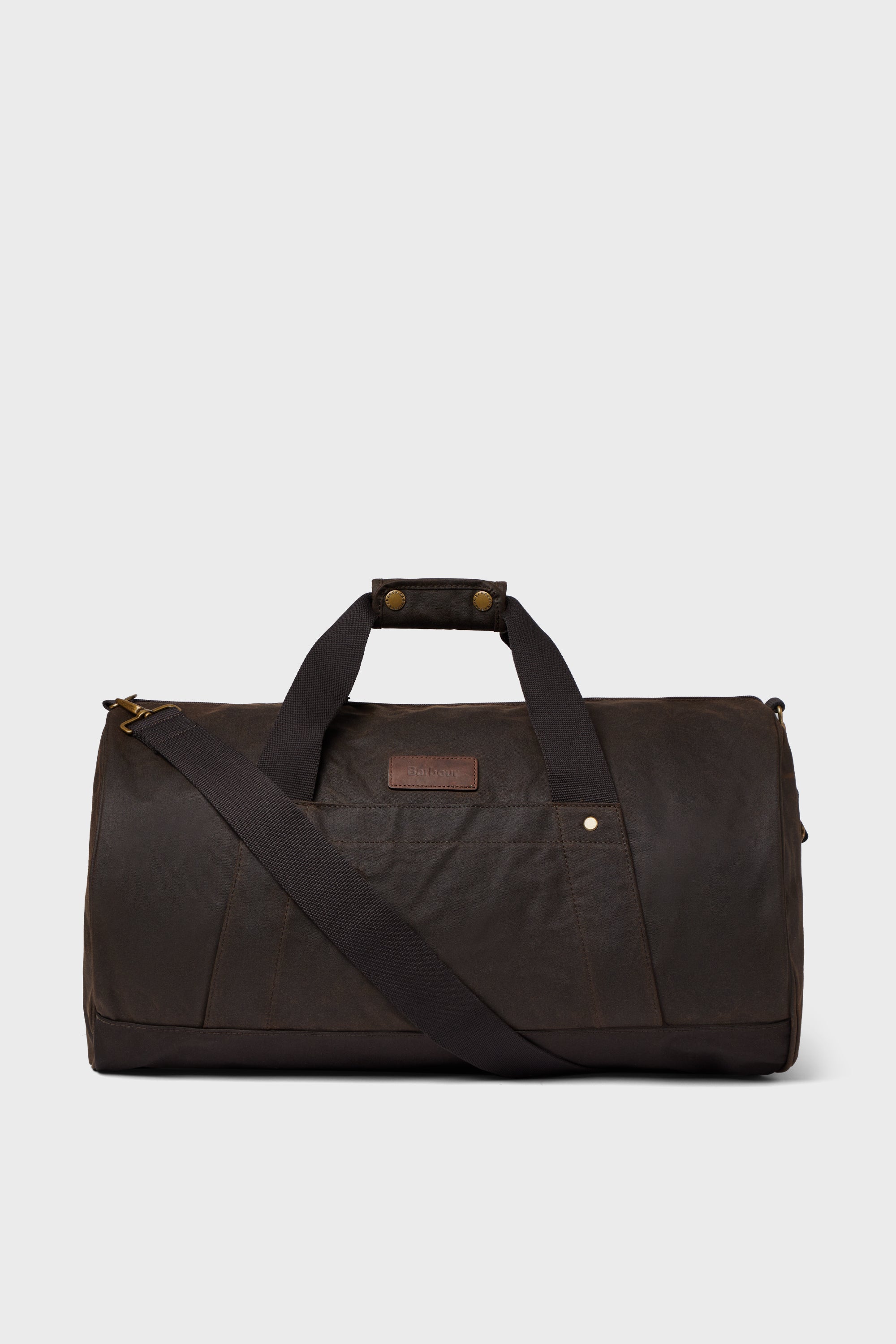 A Barbour duffle bag in dark brown featuring dual handles, a detachable shoulder strap, and a front pocket—ideal for weekend getaways.