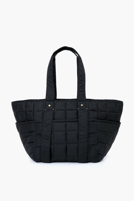 The Clare V black quilted tote bag features two handles, a rectangular shape, and grid stitching. Made from nylon, it’s both stylish and practical—ideal for carrying your essentials in a classic Clare V-inspired design.